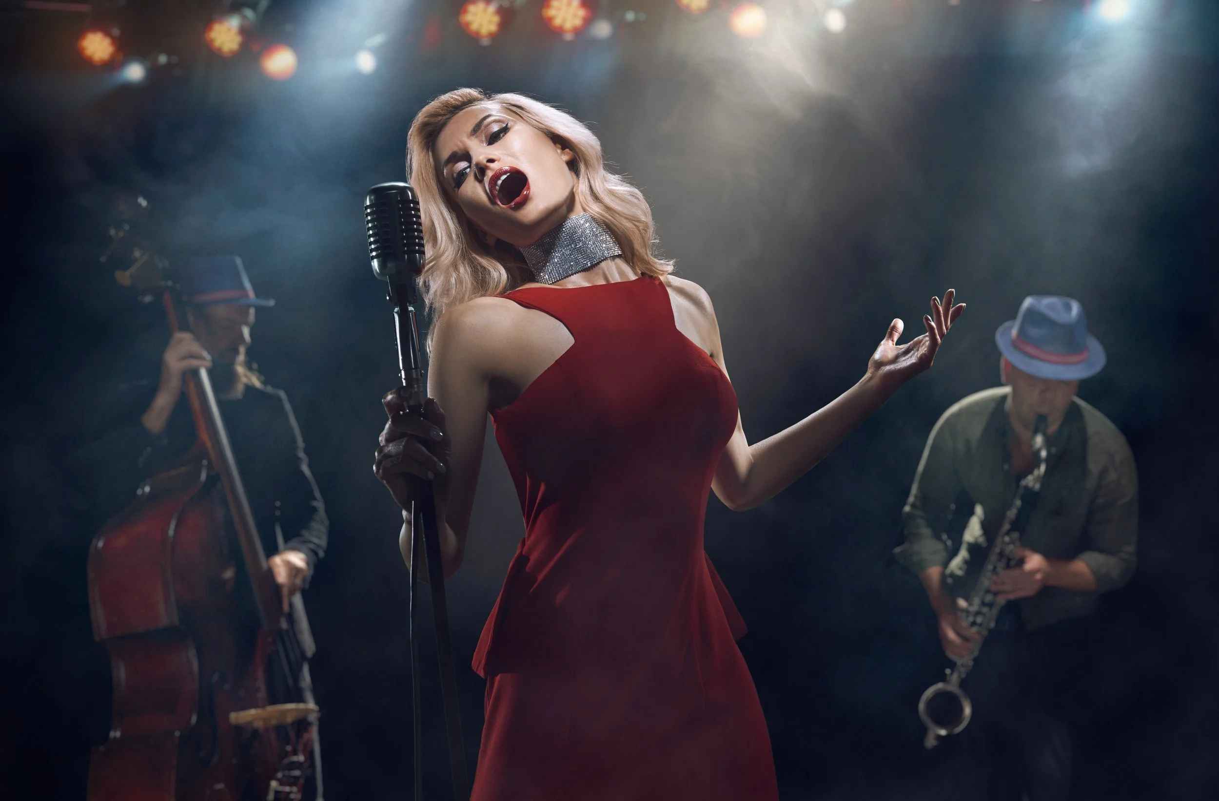 Female singer singing in front of a live audience.