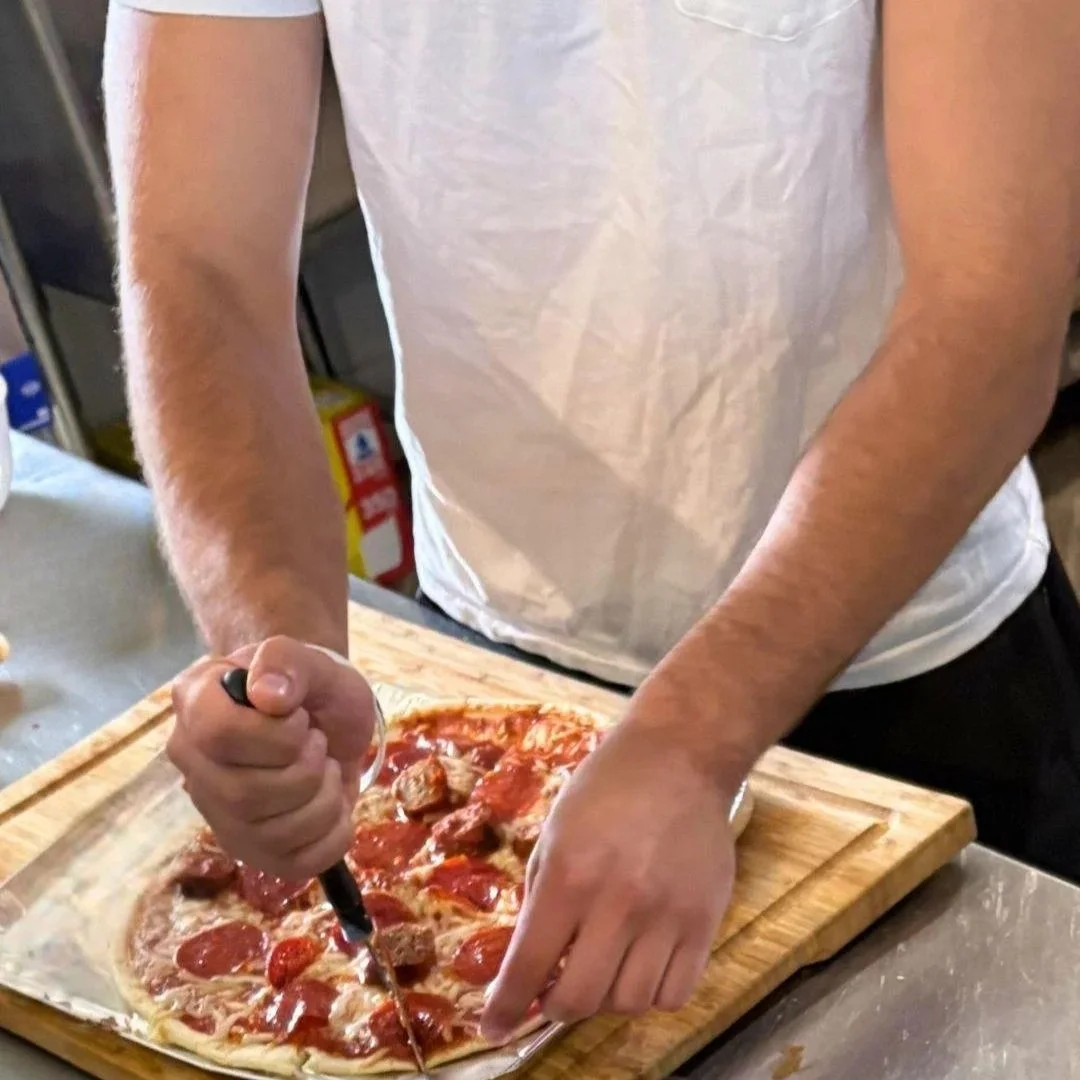 A Woodhaven Recovery student prepares a meal while developing practical life skills, independence, and confidence for life beyond treatment.