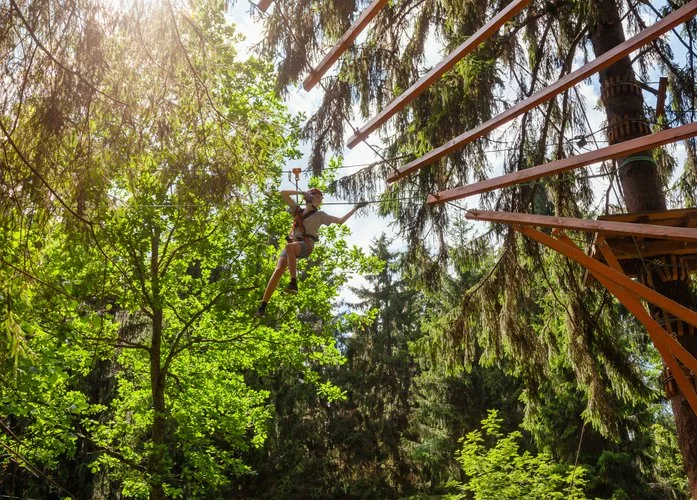 Woodhaven Recovery residents engaging in thrilling outdoor adventure courses including zipline descents, fostering teamwork, confidence, and resilience.