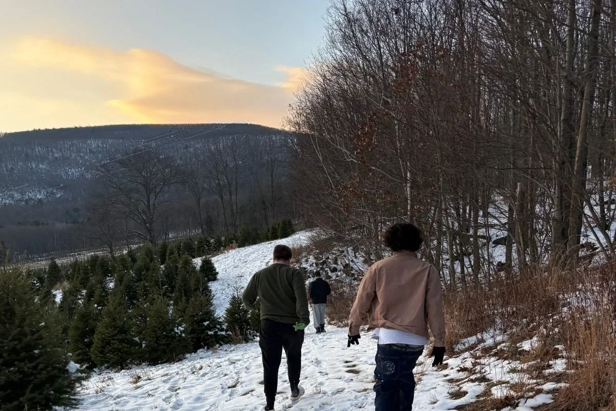 Woodhaven Recovery residents walking down a snowy hillside during a winter outdoor activity.
