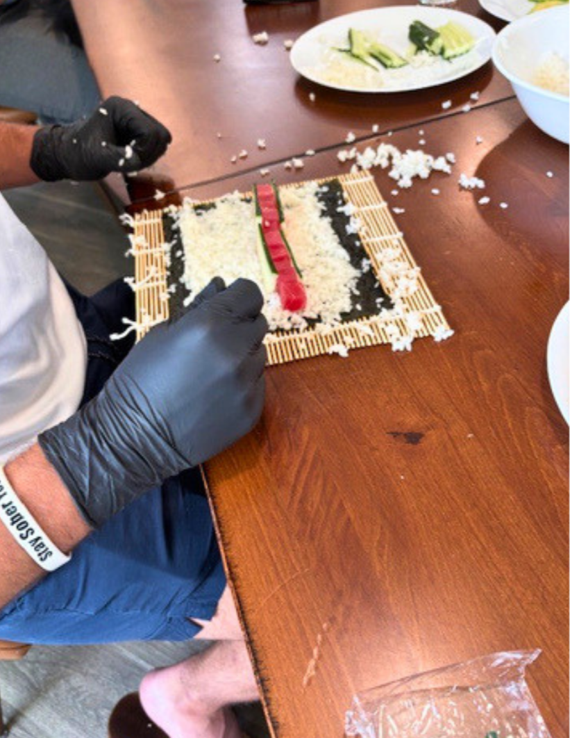 Woodhaven resident preparing sushi during a summer cooking activity