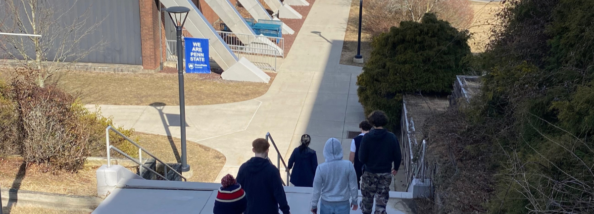 Residents walking on a college campus as part of strategic planning and next steps at Woodhaven Recovery.