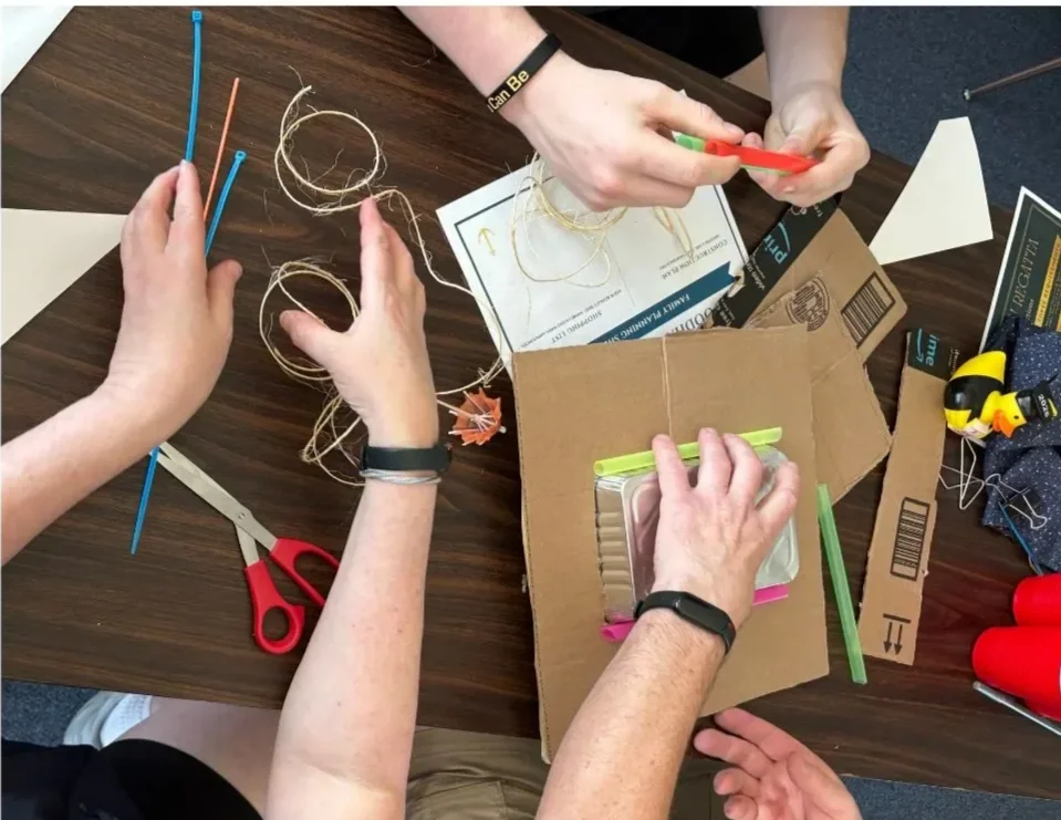 Families participating in a hands-on activity together during Family Program at Woodhaven Recovery, representing connection, learning, and shared healing.