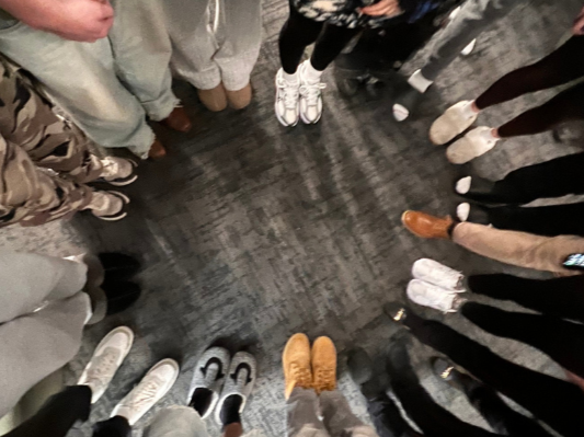 Woodhaven Recovery residents standing in a circle during a visit to Guardian Recovery, representing peer support, connection, and shared recovery experience.