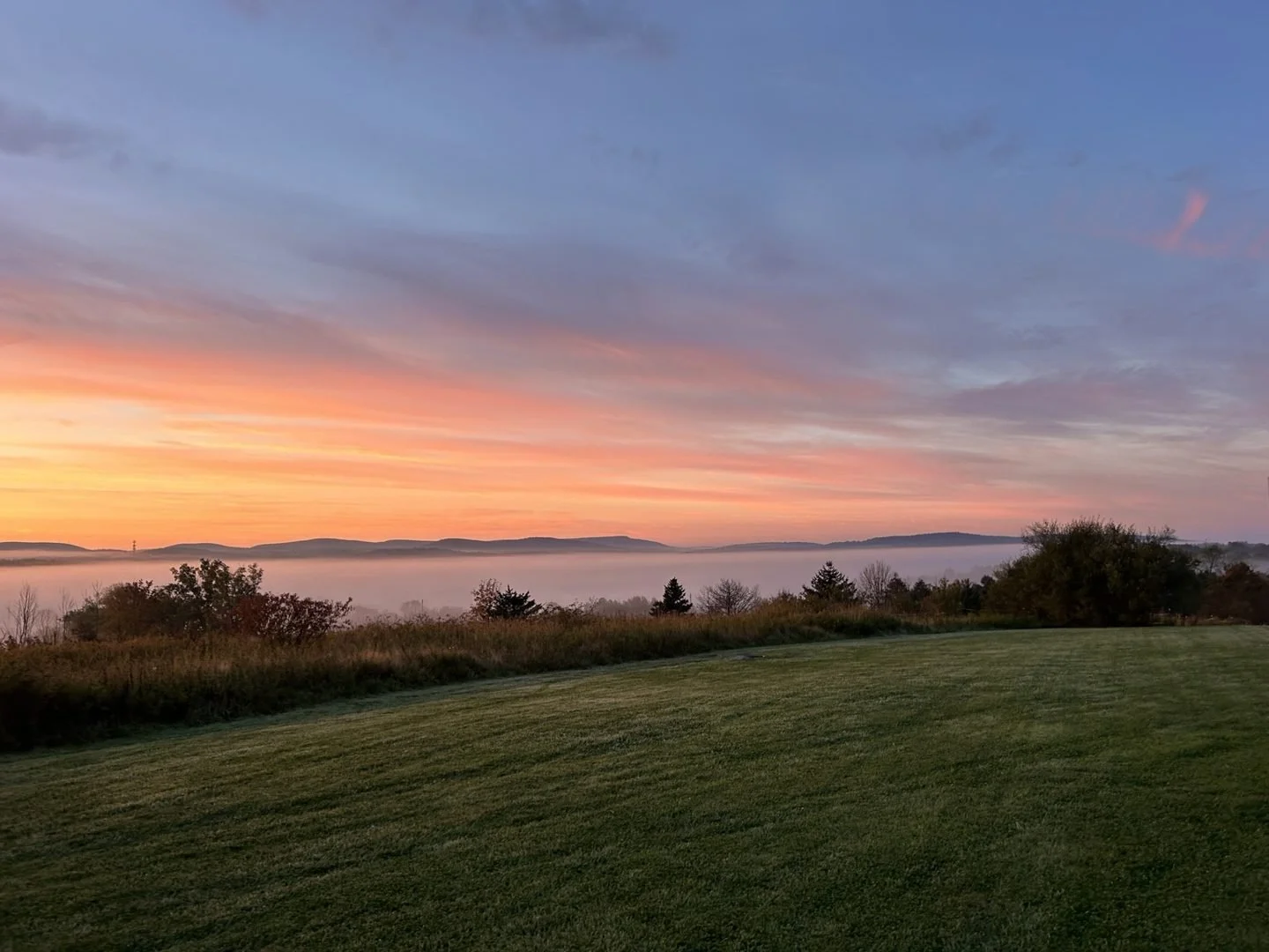 Sunrise over a mist-filled valley at Woodhaven Recovery in Northeastern Pennsylvania, reflecting a peaceful setting for hope and healing.