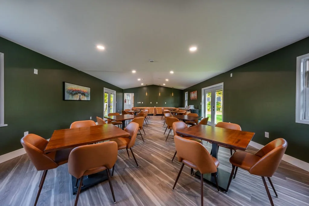 Dining room at Woodhaven Manor where residents, staff, and families gather for shared meals and community.
