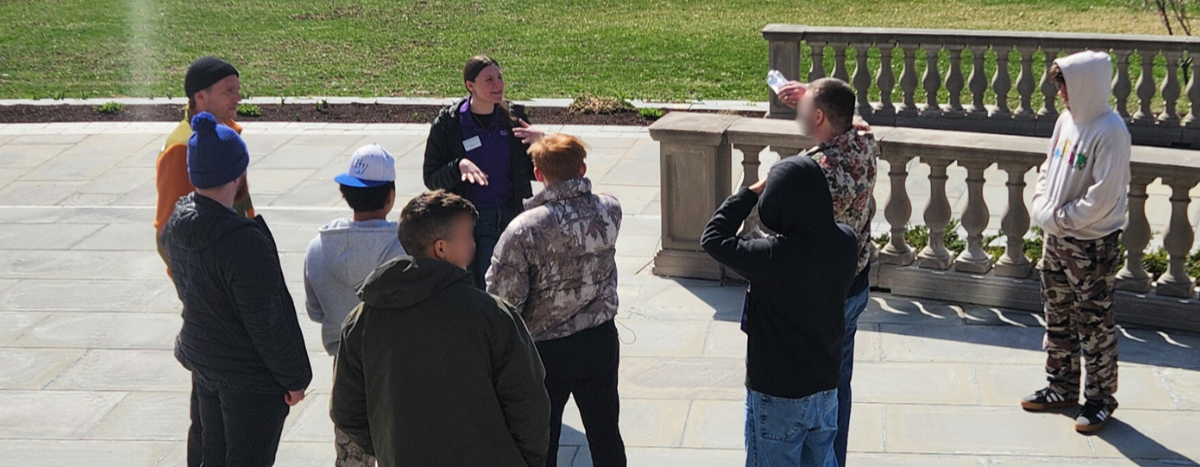 Residents gather outdoors during a college campus visit as part of Woodhaven Academy.