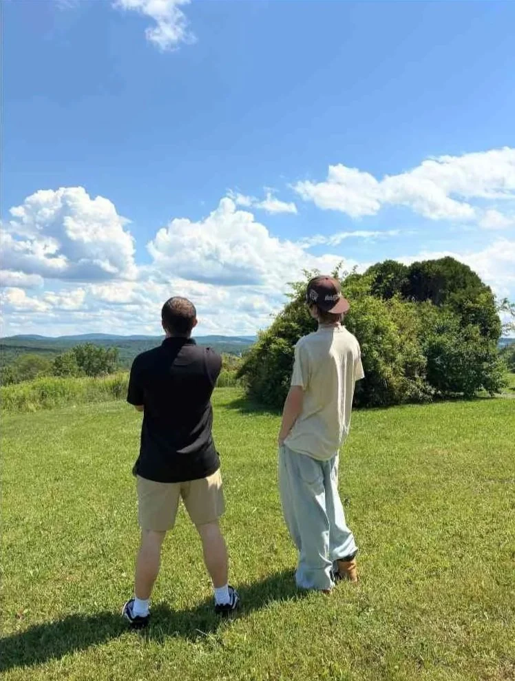 Woodhaven resident and staff member standing outdoors during an individual recovery coaching conversation.