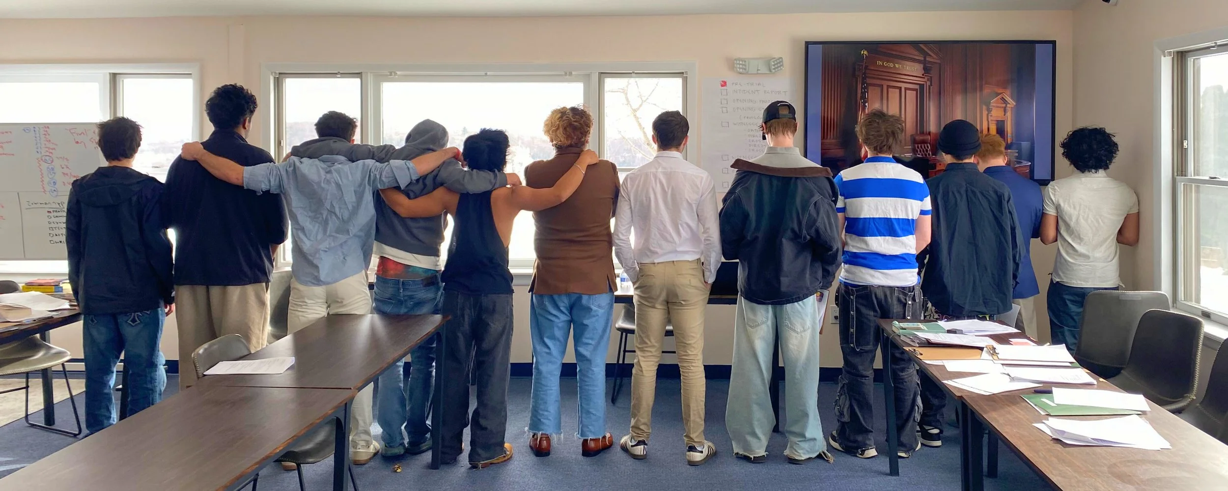 Woodhaven Academy students standing side by side in a classroom, reflecting connection, growth, and academic engagement in recovery.