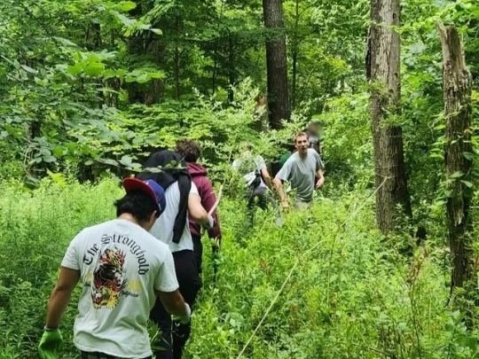 Woodhaven Recovery residents hike through the wooded campus, building connection, confidence, and appreciation for nature through outdoor exploration.