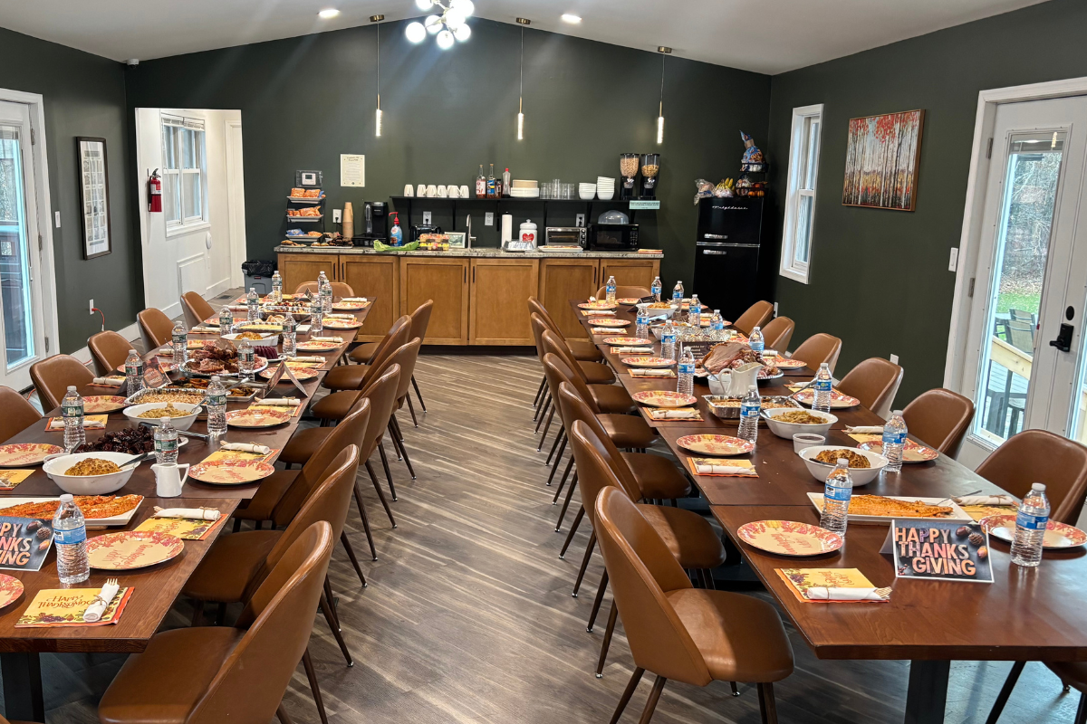Thanksgiving meal at Woodhaven Recovery, where young men in recovery and staff share connection, routine, and a sense of belonging