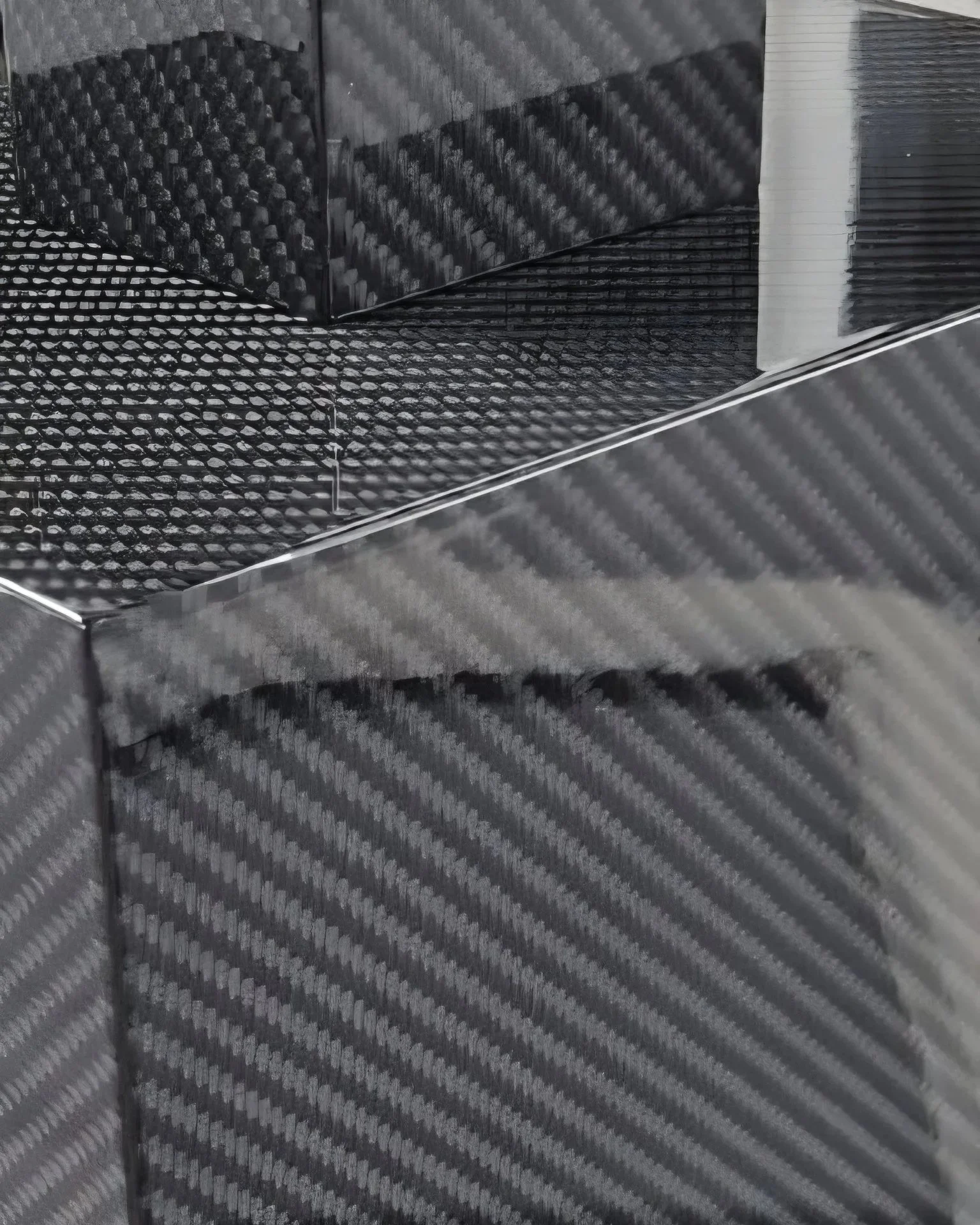 Close-up of four black boxes with different textured surfaces.