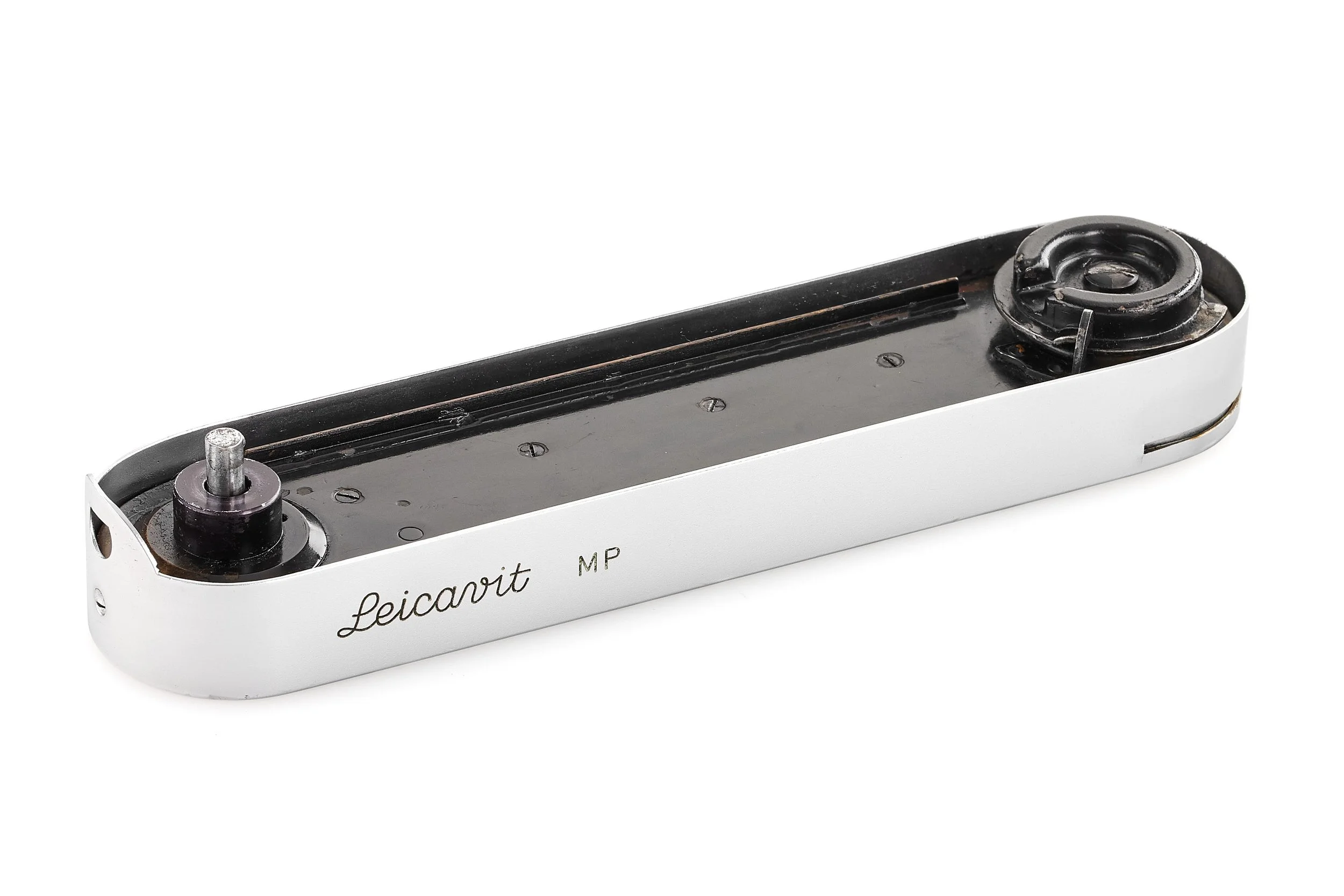 Disassembled film camera with white body, showing internal components like the film spool and take-up reel.