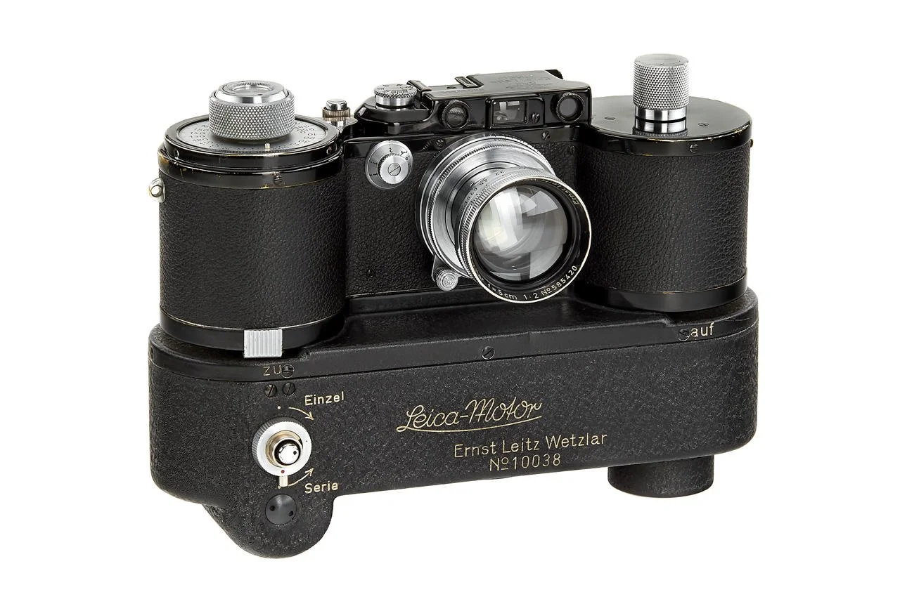 Vintage Leica camera with lens on a black base