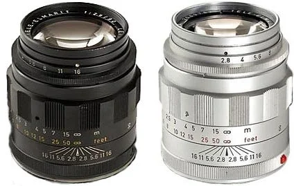 Two camera lenses, one black and one silver, placed side by side.
