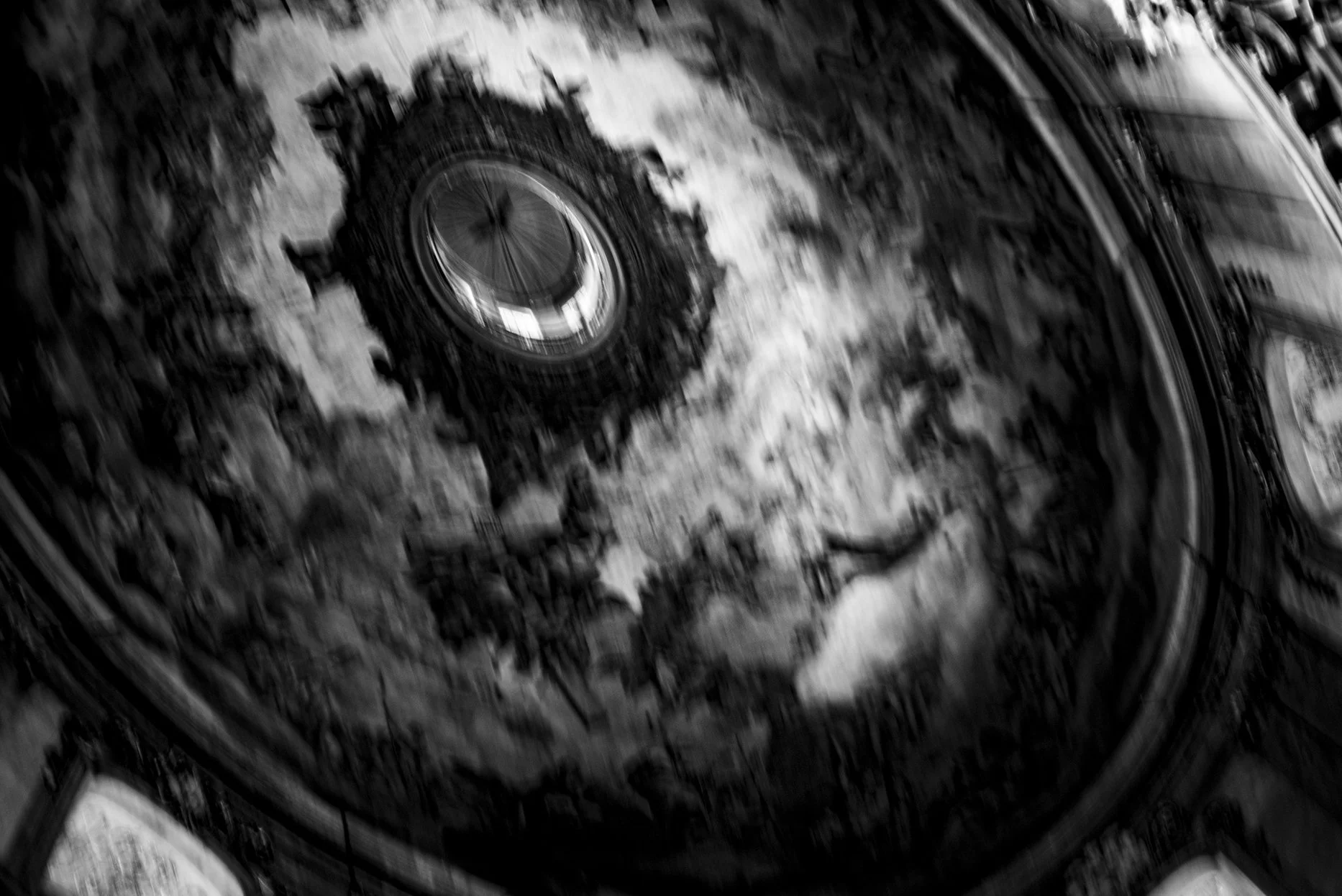 Close-up of a vintage mechanical watch movement with visible gears and components, in black and white.