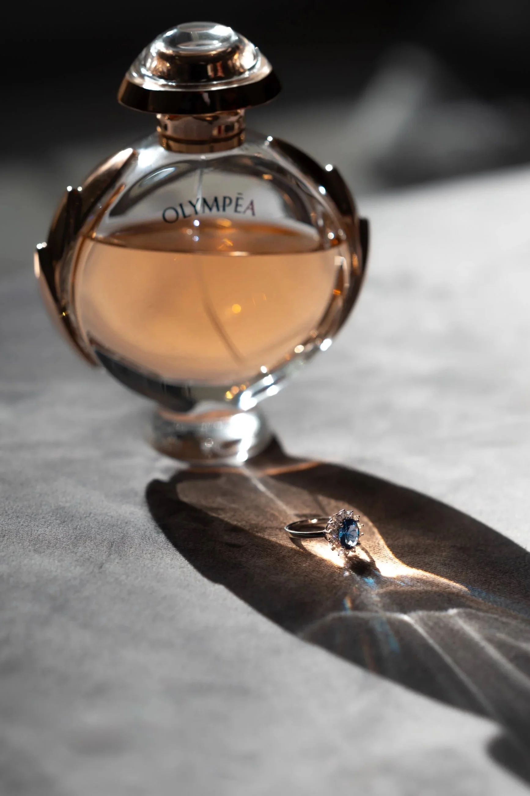 Creative shot of a wedding ring. I put the perfume bottle in front of the ring, so that the sun beams create some nice reflections in the colours of the perfume