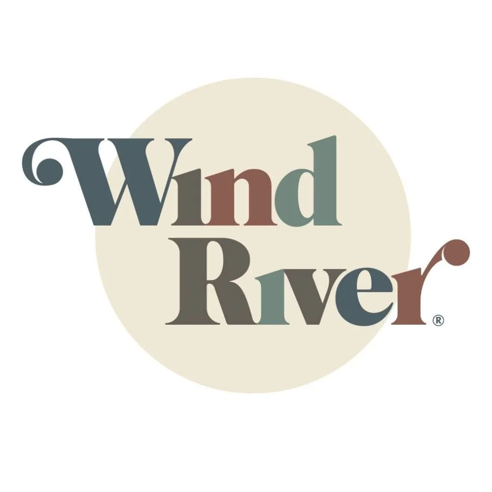 The logo for Wind River, featuring stylized text 'Wind River' with a circular background and a subtle design element resembling a wind motif.