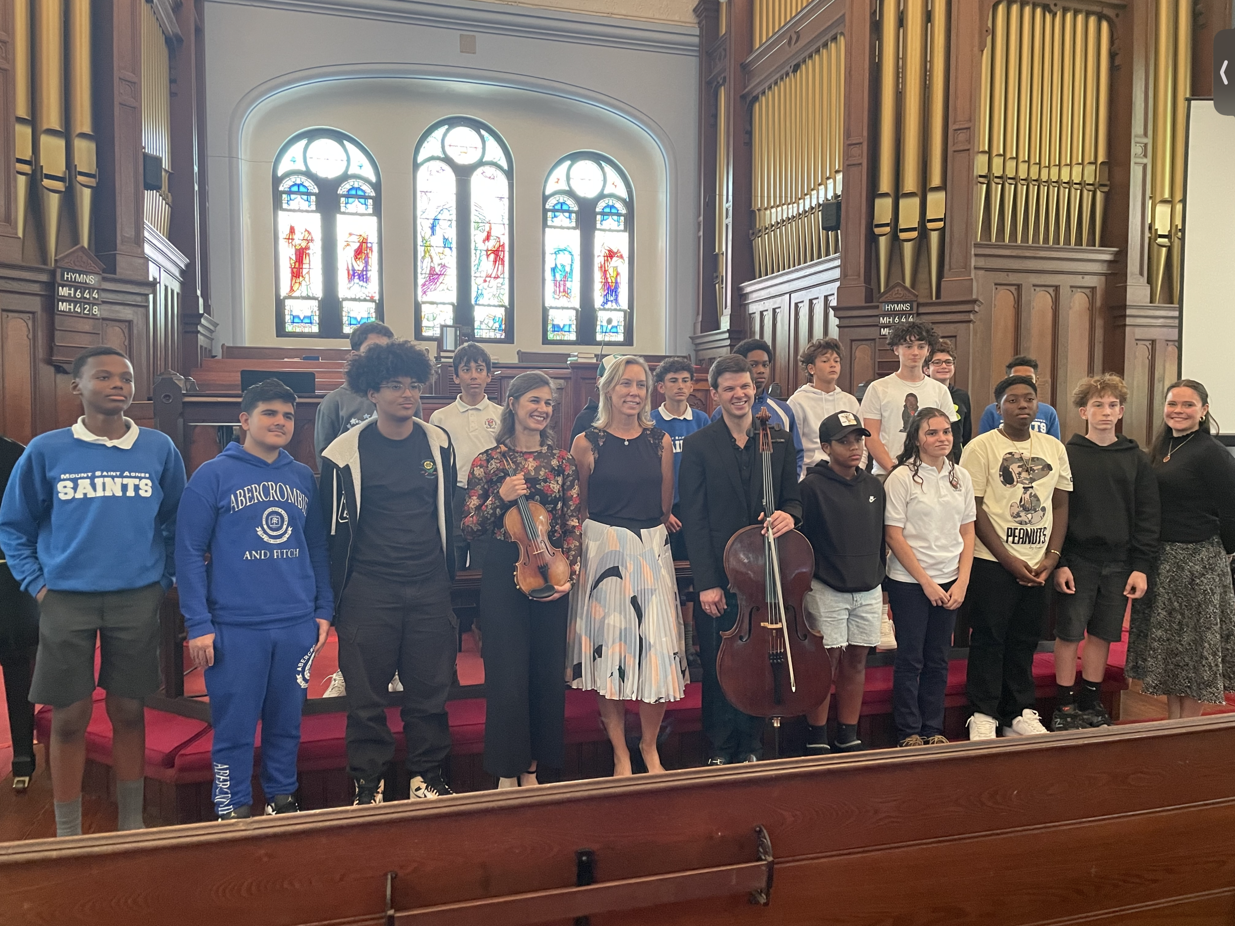 Musicians with student audience members after a free afternoon concert, part of the festival’s commitment to offering complimentary student tickets.