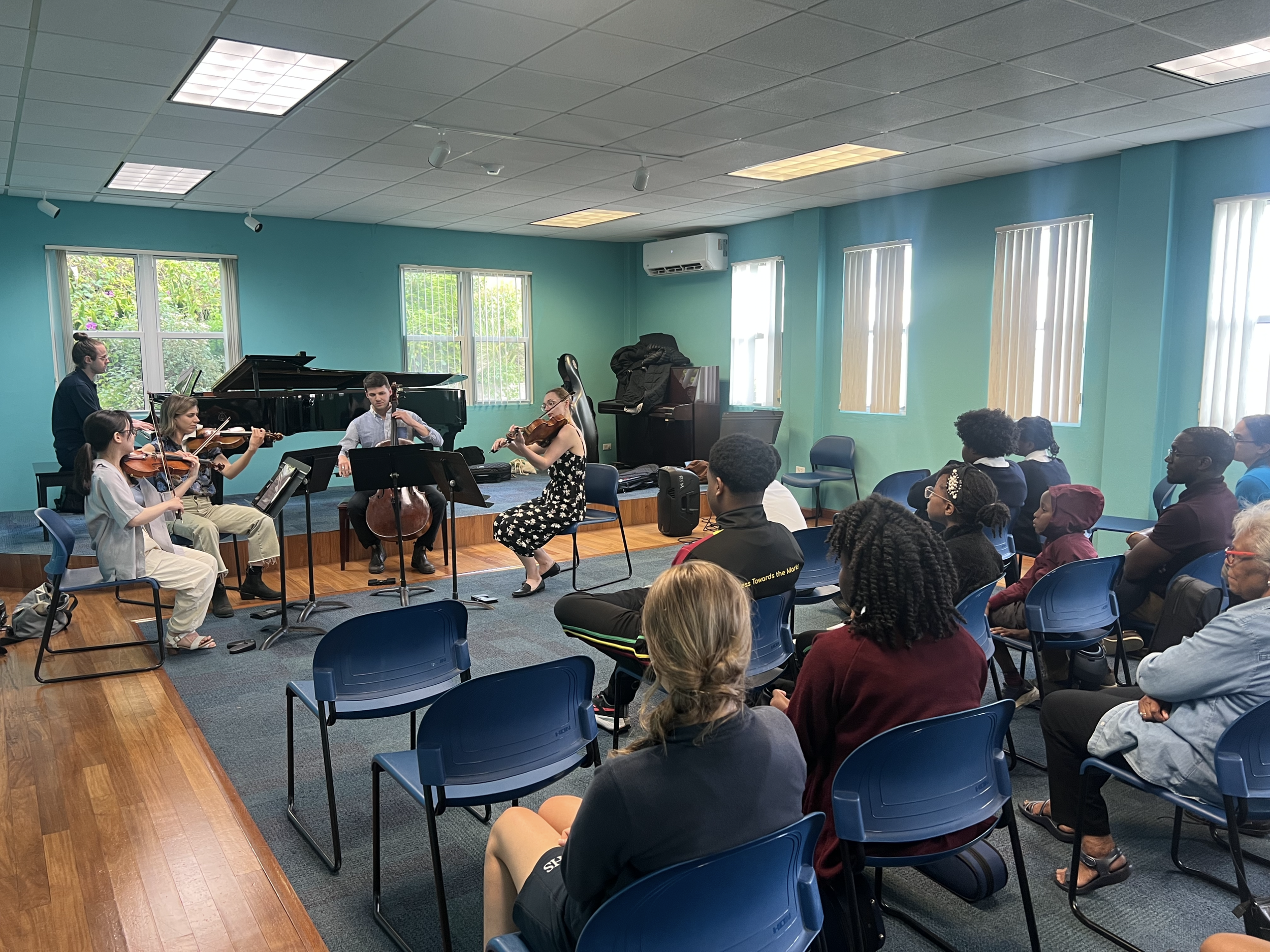 Music students from across the island and their parents experience chamber music up close through a demonstration and performance led by festival guest artists.