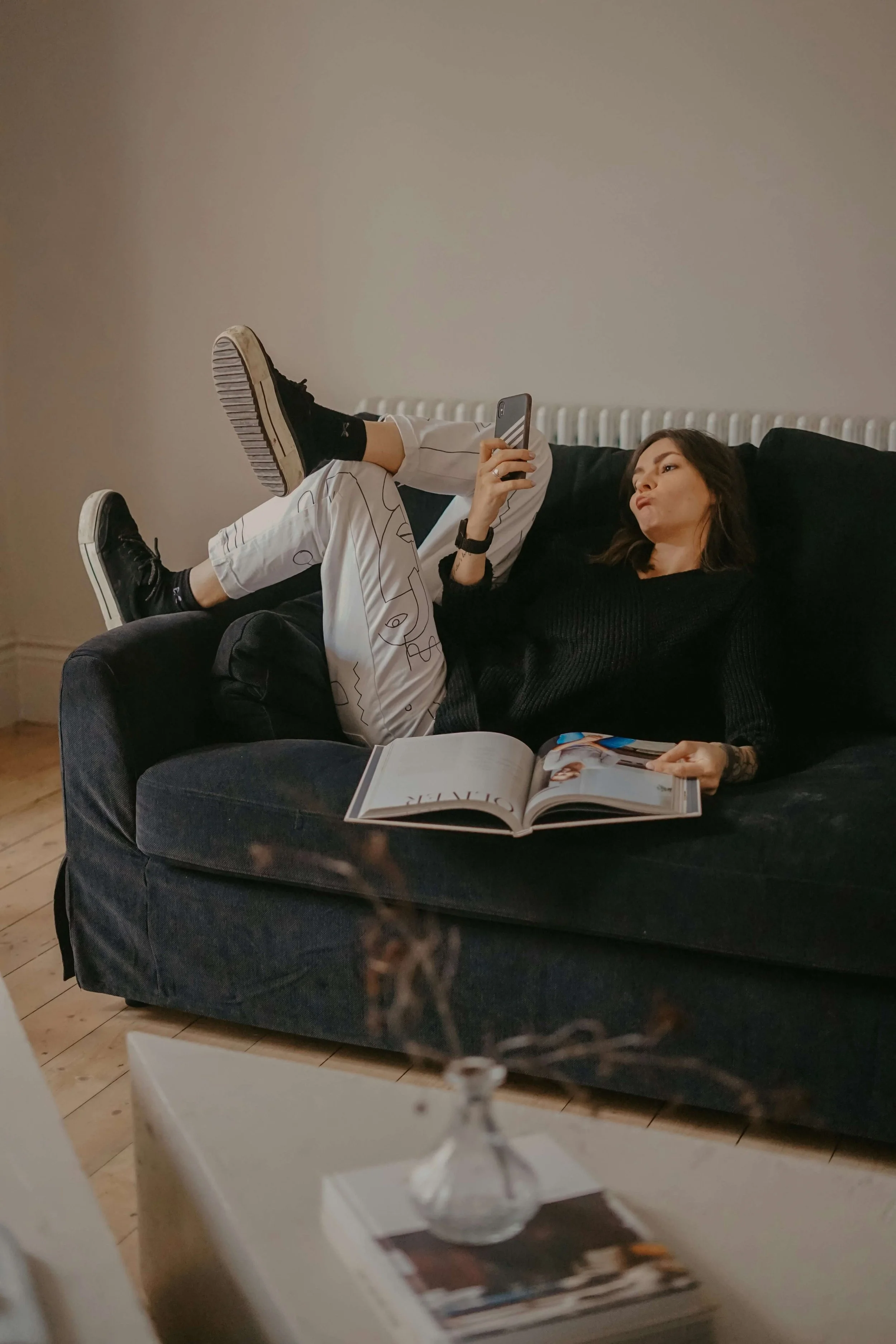 a woman on the couch holding her phone