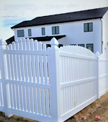 White picket fence in front of a house