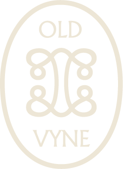 An oval-shaped logo with the words 'OLD VYNE' and a decorative symmetrical design in the center.