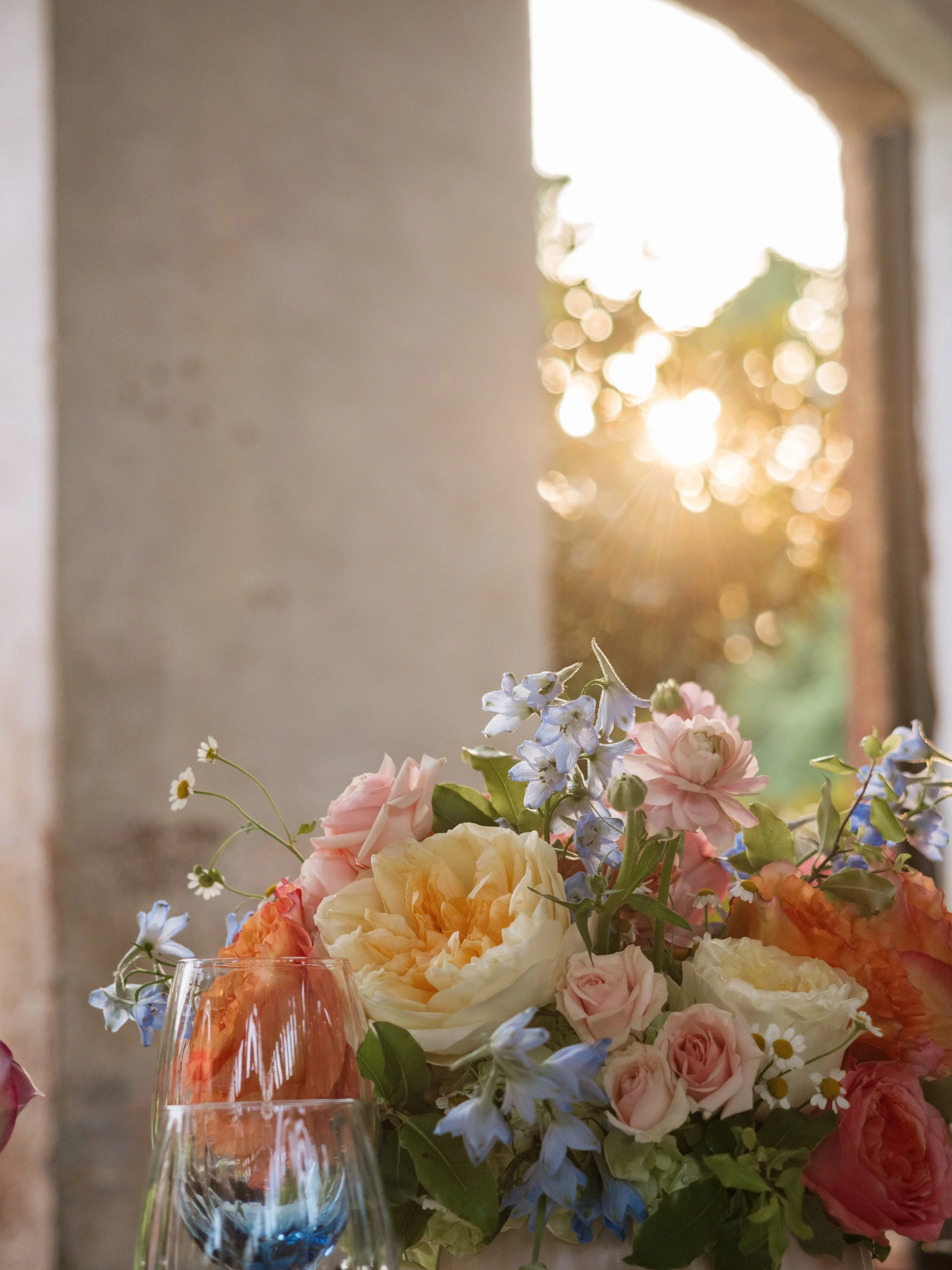 Garden style centerpiece with garden roses, delphinium, and ranunculus at providence cotton mill..jpg
