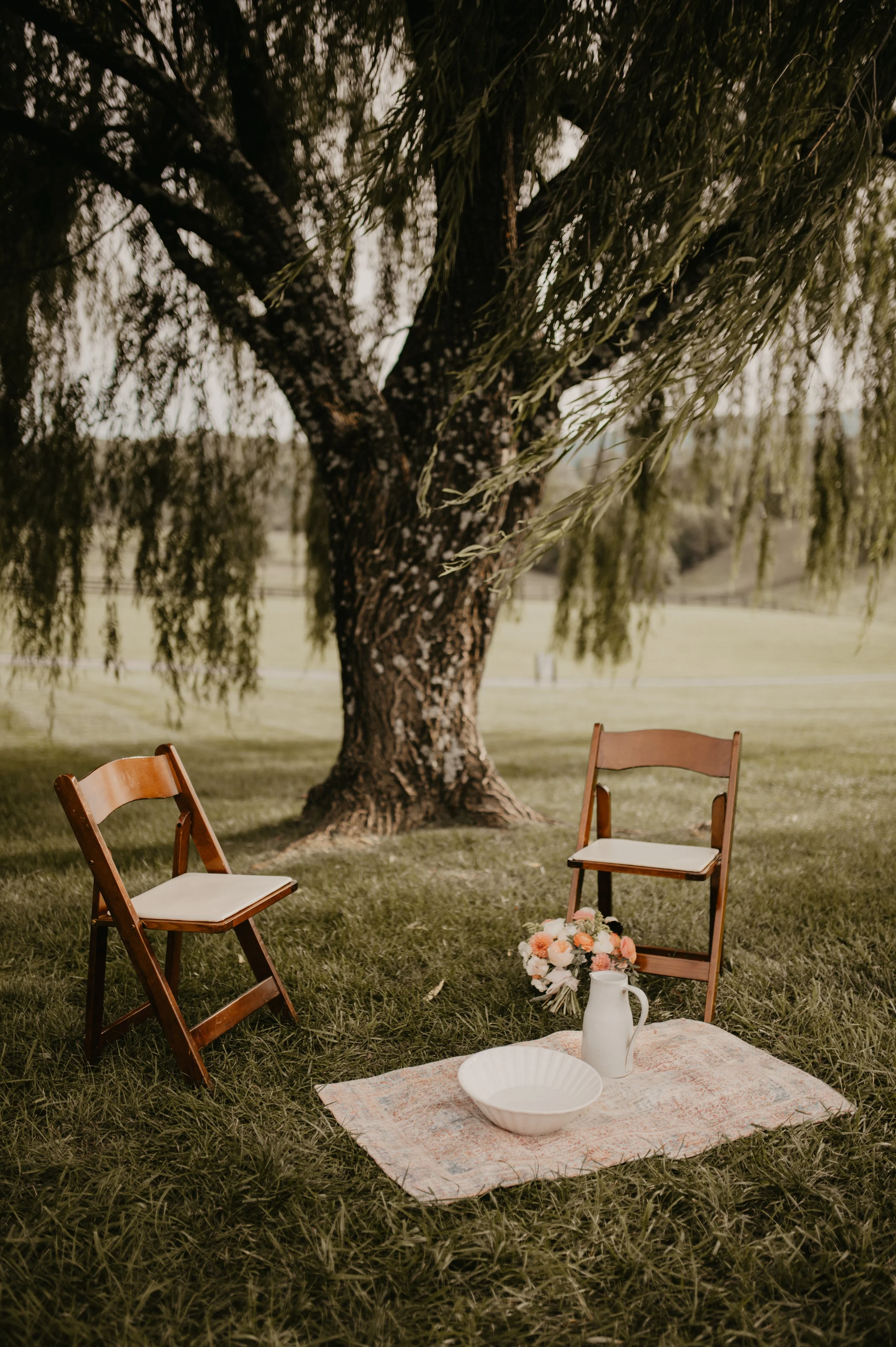 Feet washing ceremony setup beneath a willow tree at a wedding at The Shiloh in North Carolina