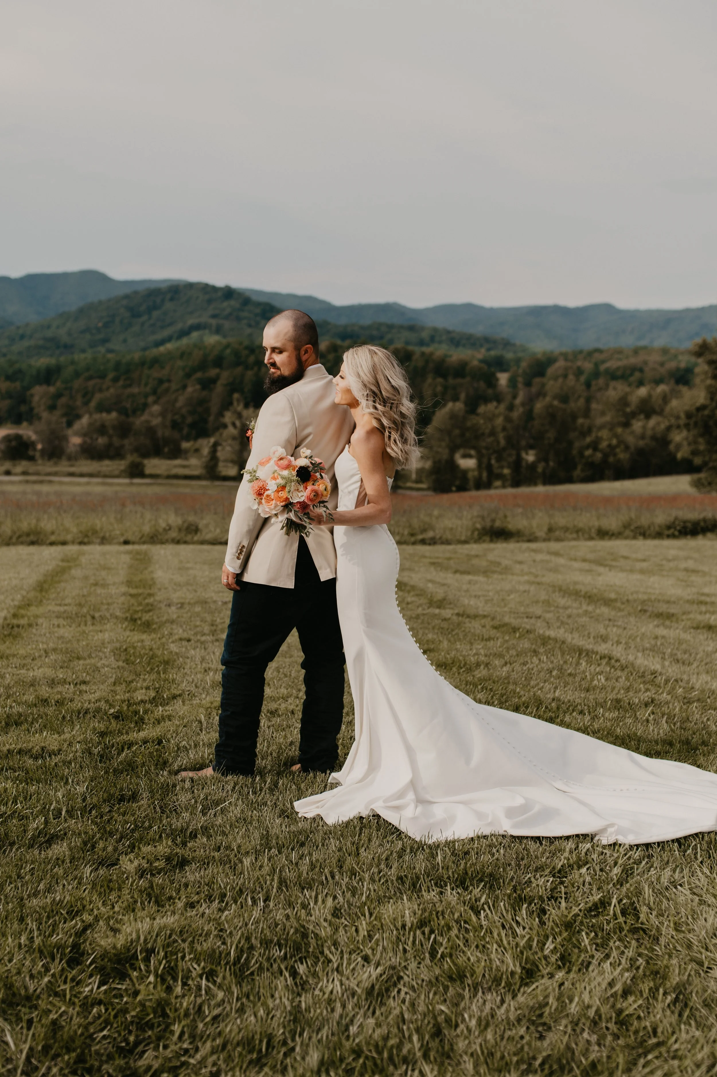 Bride and groom at a moody end-of-summer wedding at The Shiloh in North Carolina with garden-style florals by an NC wedding florist