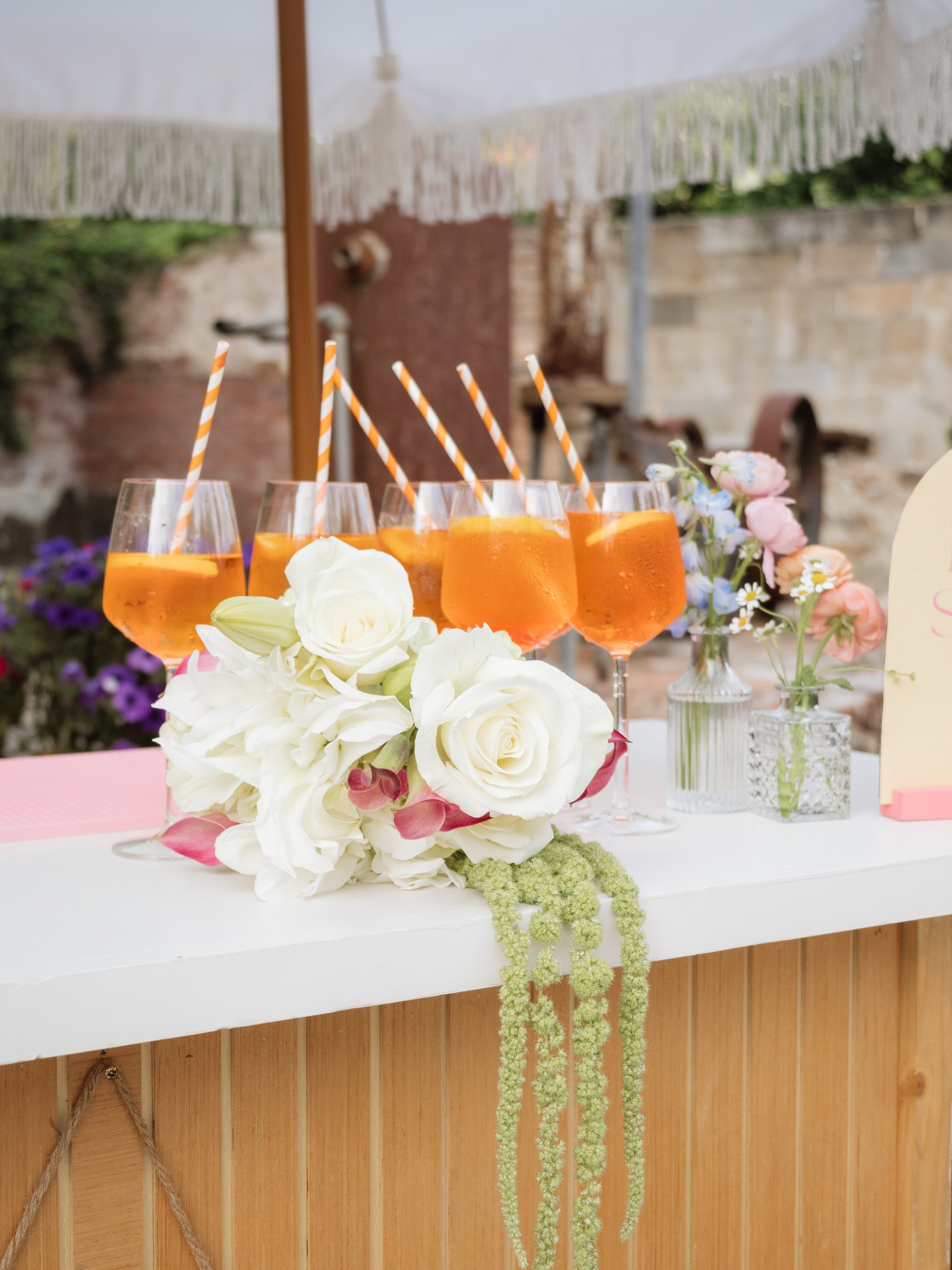 Modern pink, green, and white wedding bouquet on bar..jpg