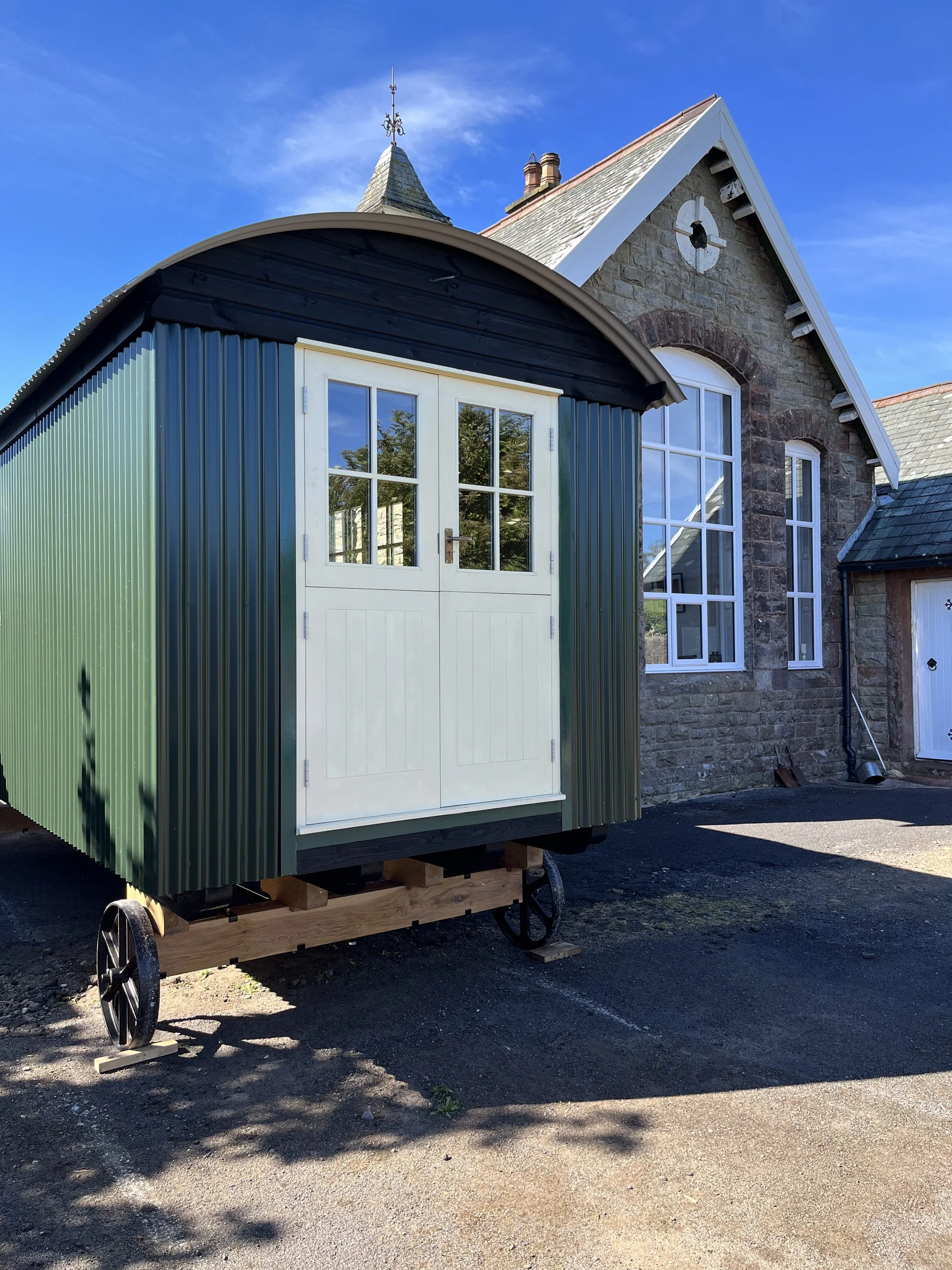Shepherds hut outside old building.jpg