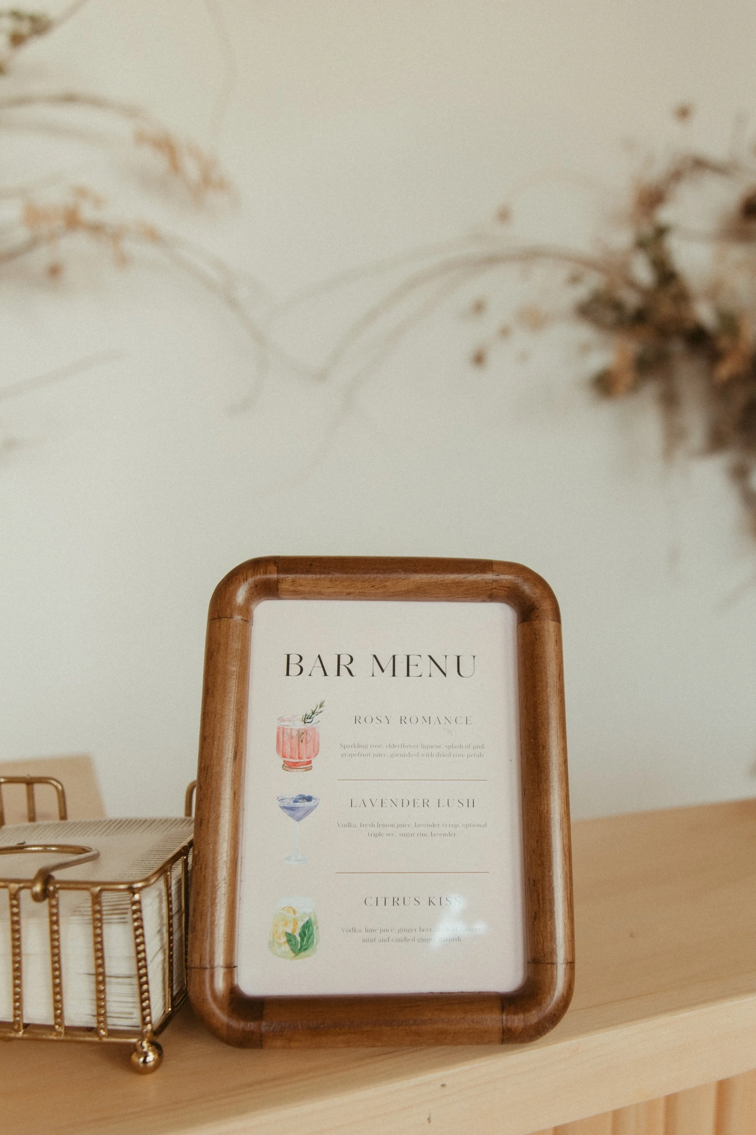 Custom Bar menu displayed in a wooden frame on a light wooden portable bar for a wedding