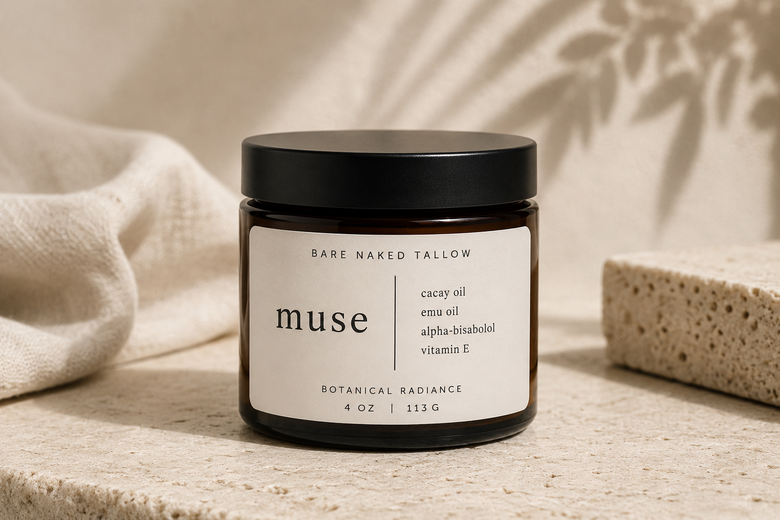A dark amber jar with a black lid and label, containing a skincare product called 'Muse' by Bare Naked Tallow, placed on white satin fabric.