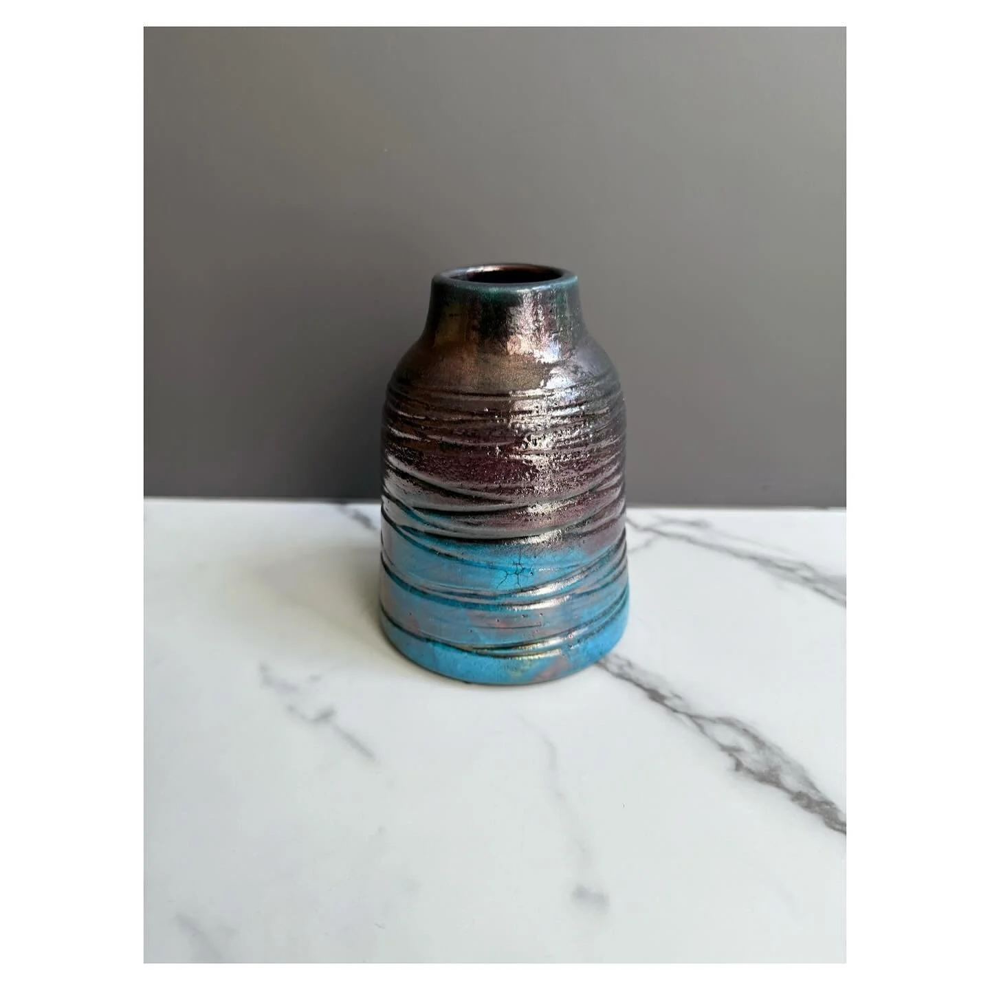 Turquoise raku glaze. Not sure how it the top became copper, but I love the gradation it made