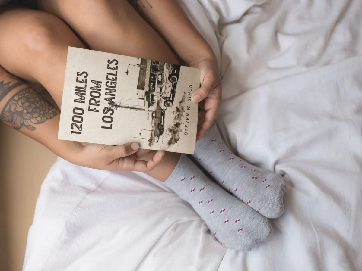 woman-holding-1200-miles-from-los-angeles-near-her-feet-while-in-bed-a17305(1).jpg