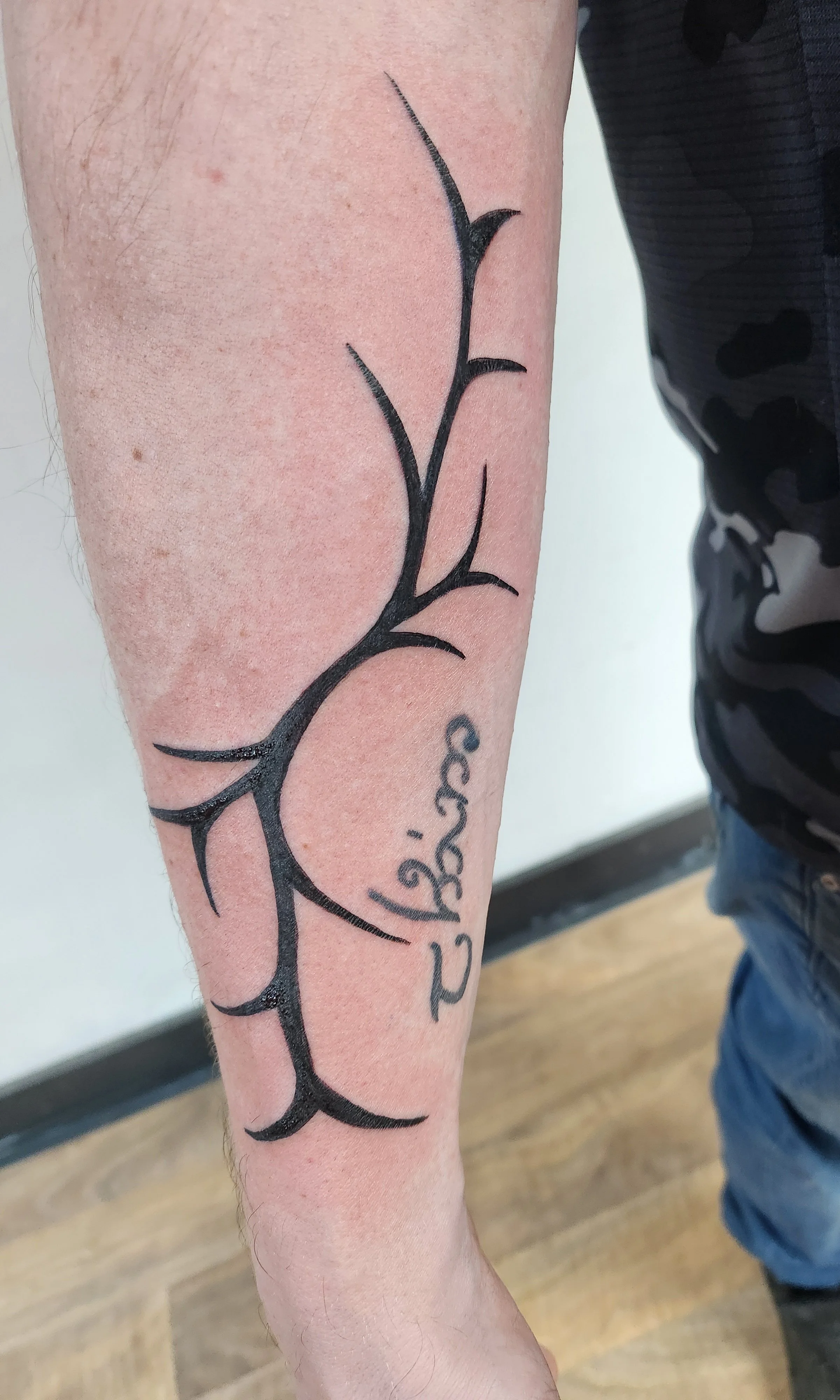 Tattoo of abstract sharp clean lines on a forearm