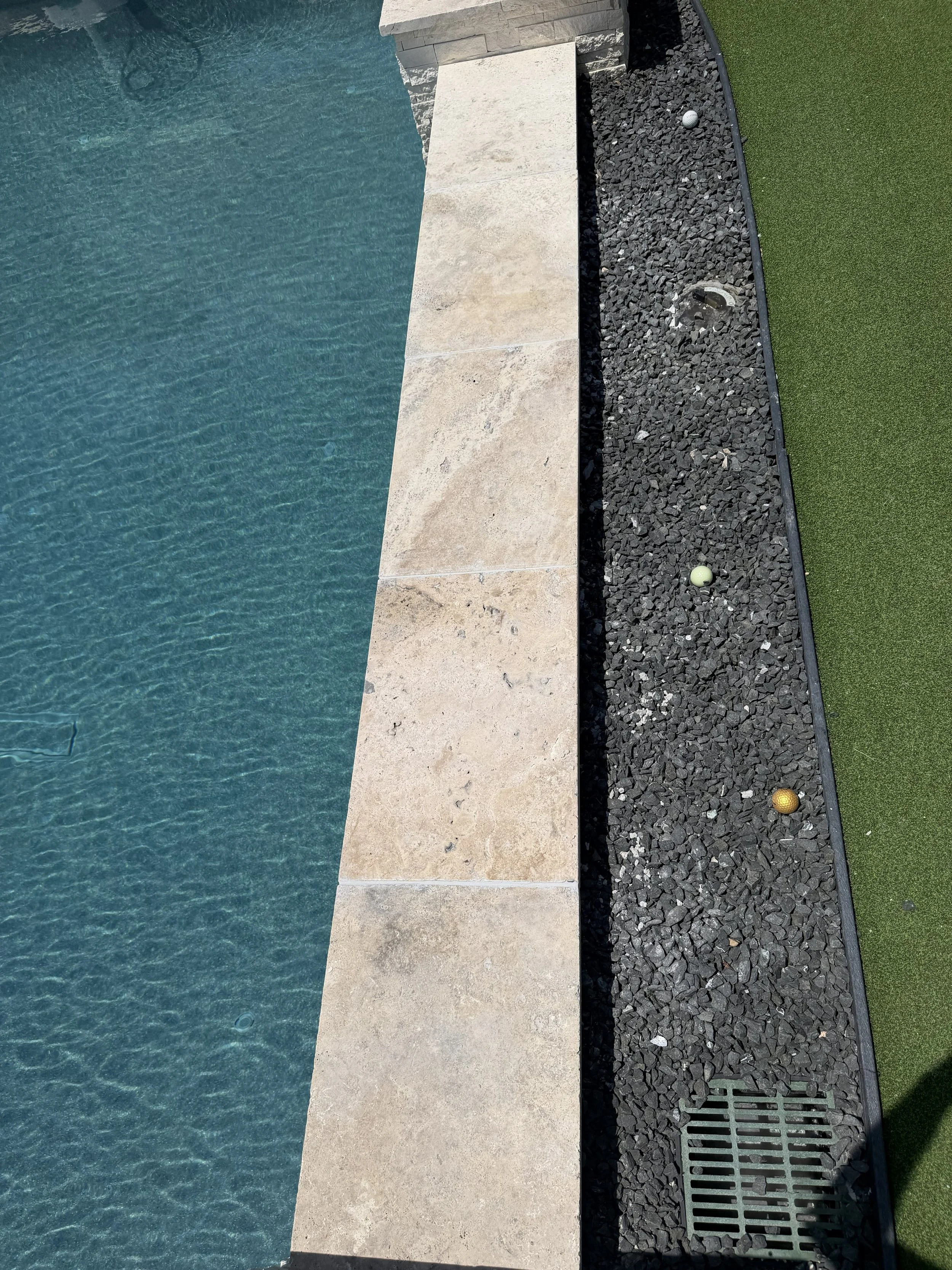 Original stone coping reinstalled over a concealed aluminum support plate