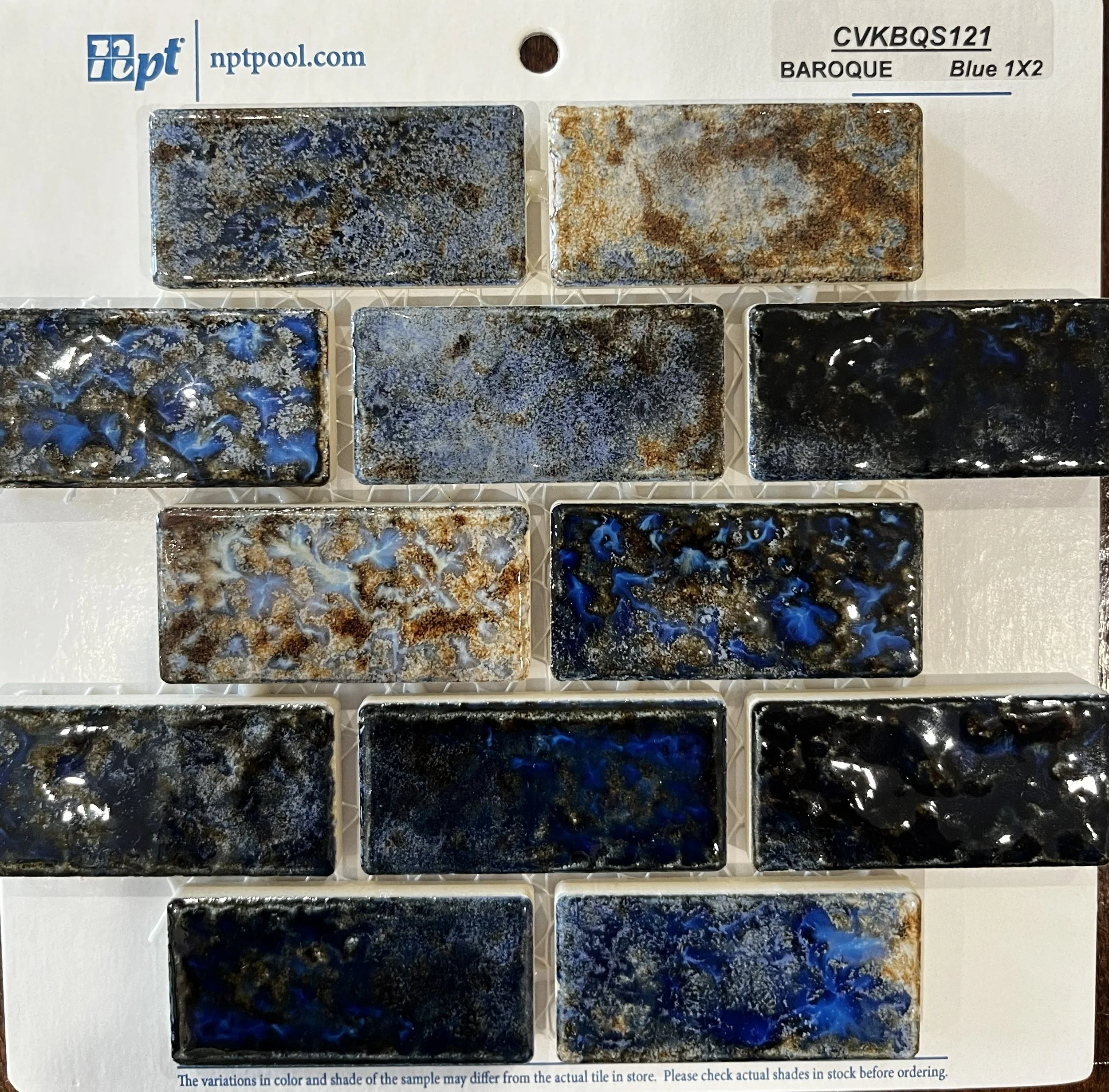 Blue NPT Baroque Stone glossy accent tile with travertine pool coping