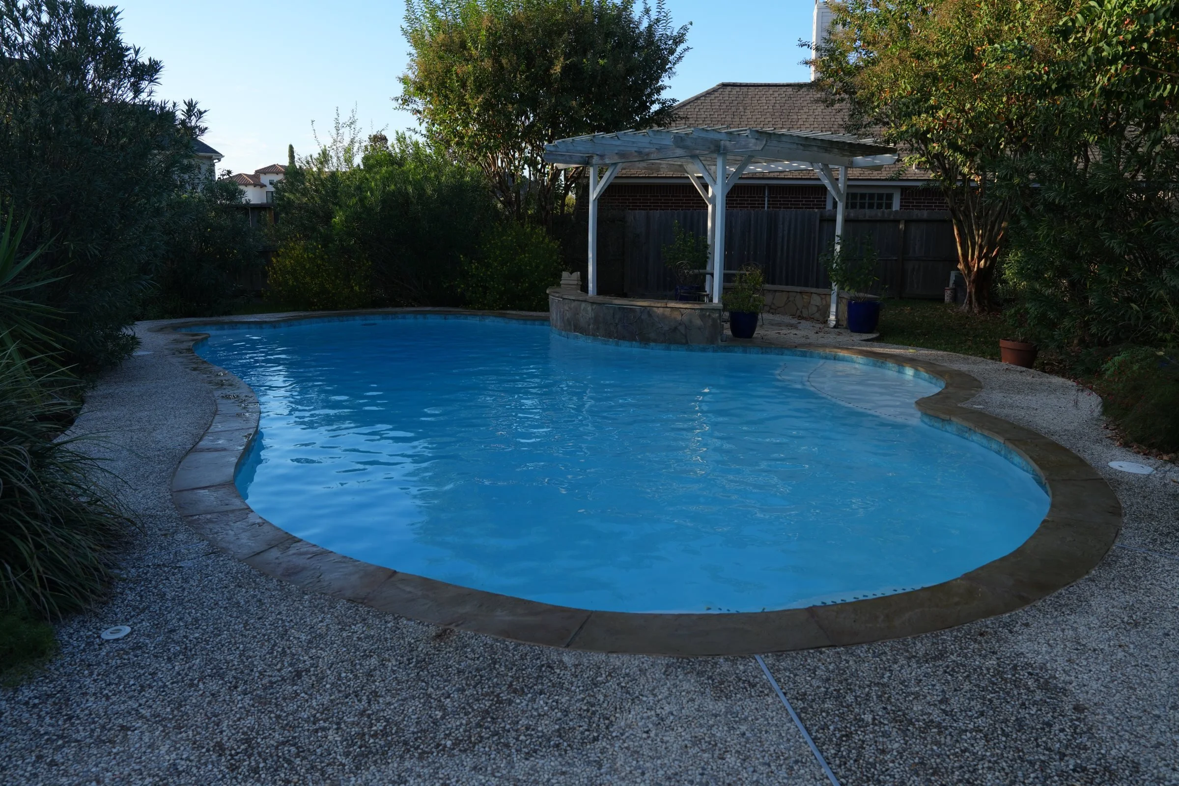 South Shore Harbor pool after white plaster, Marina waterline tile, and Aqua Blue accent tile.