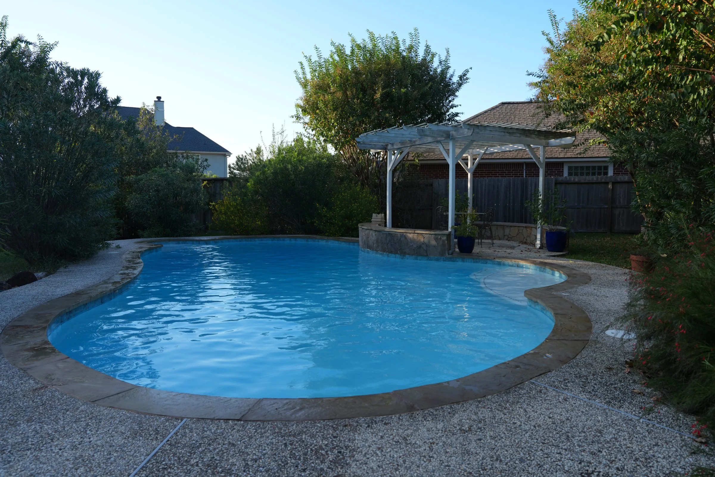 South Shore Harbor pool with white plaster, Marina waterline tile, Aqua Blue accents, and sealed coping.