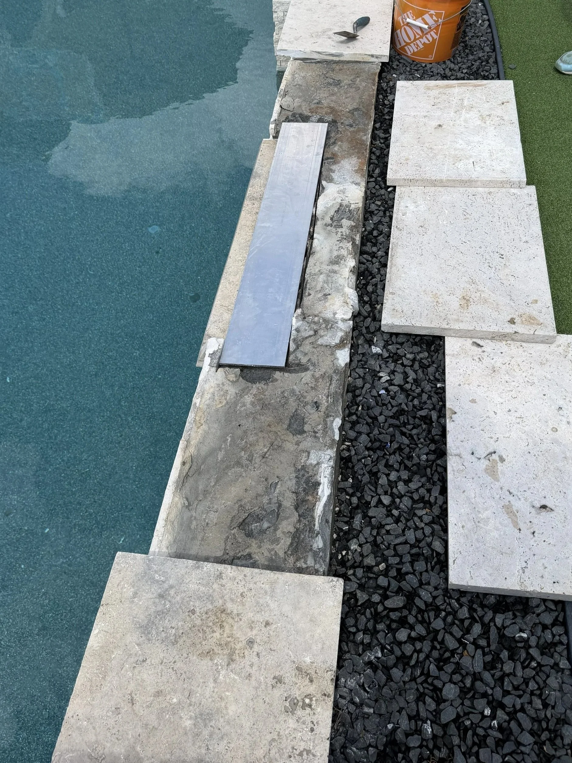 Custom aluminum support plate spanning an opening beneath removed pool coping