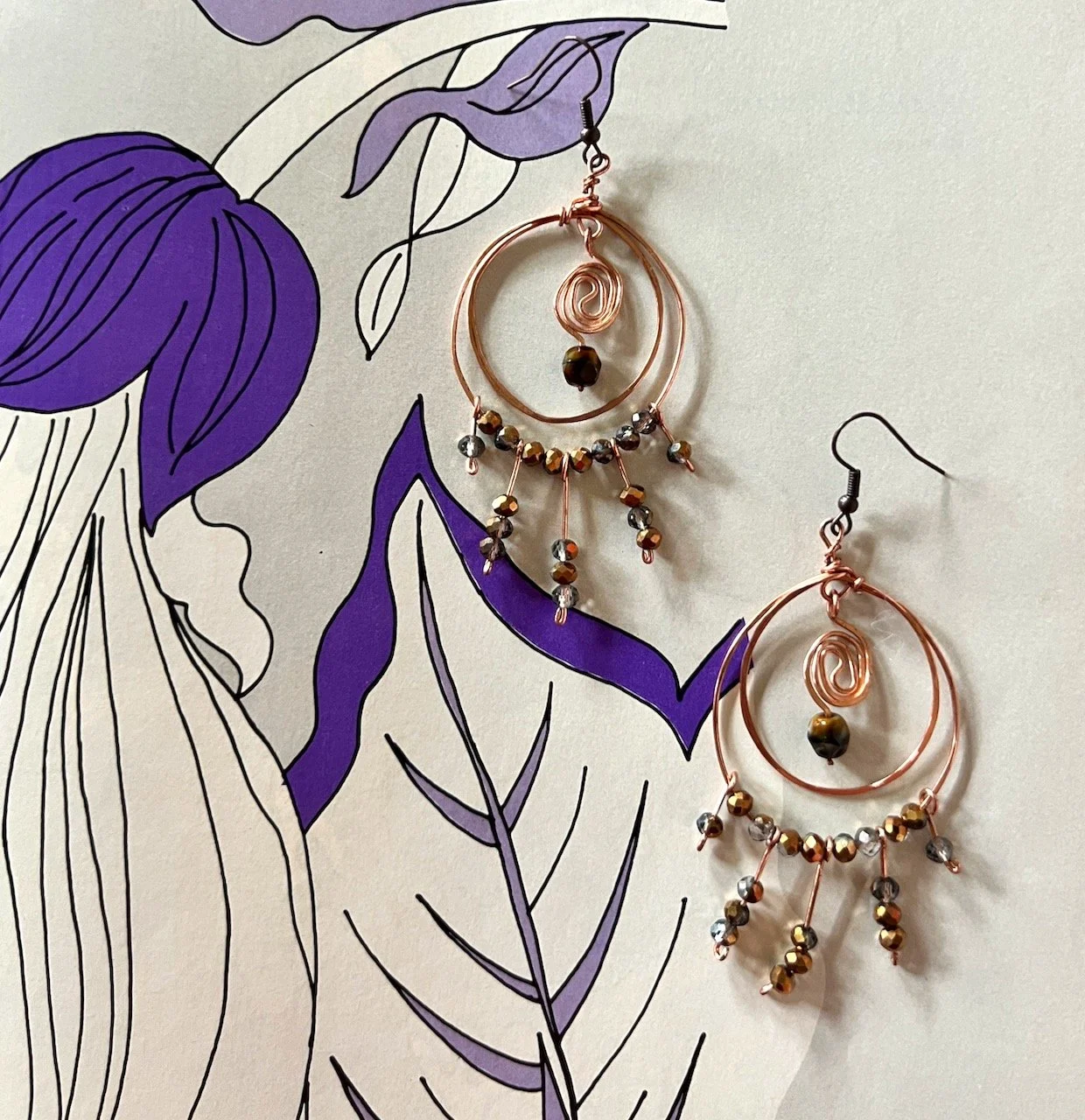 Hand-hammered rose gold hoop earrings with beaded accents