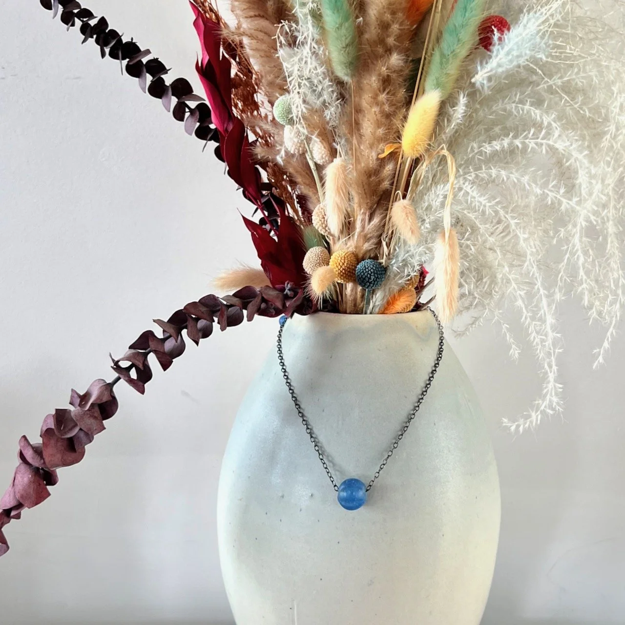 Necklace with frosted blue molded glass bead