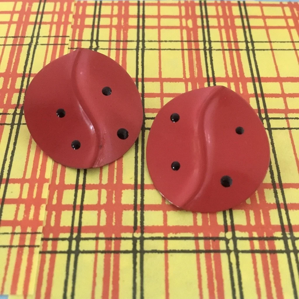 Red stud earrings with black dots