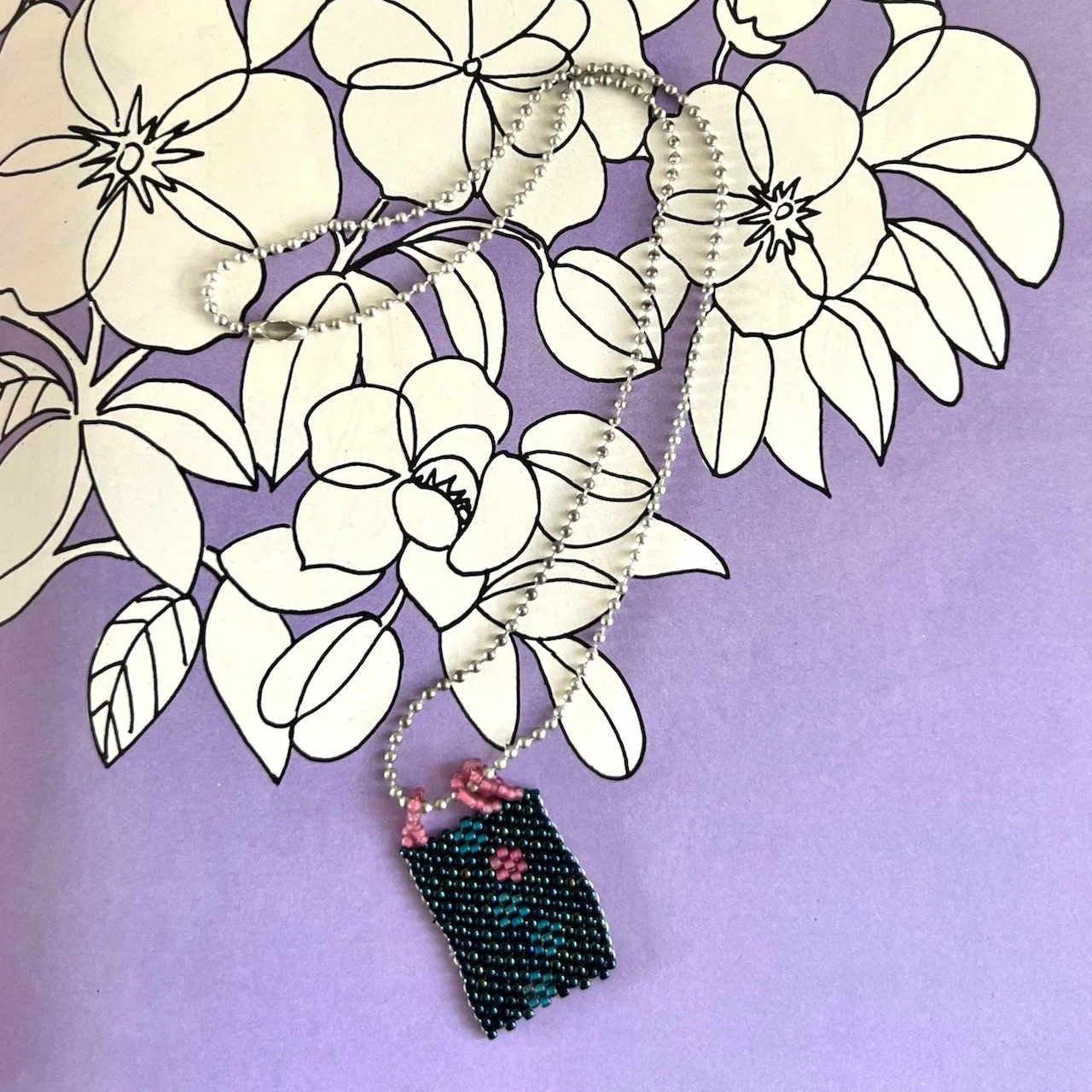 Peyote stitch banner pendant with silver tone ball chain