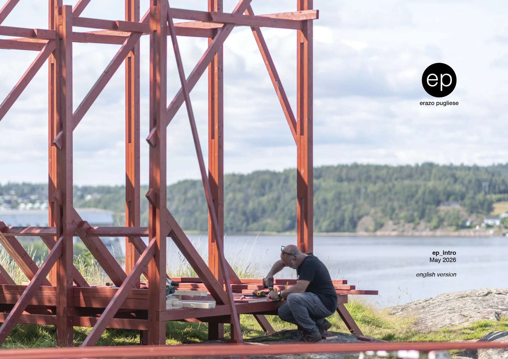 A person using a handsaw to cut a wooden red post during construction.