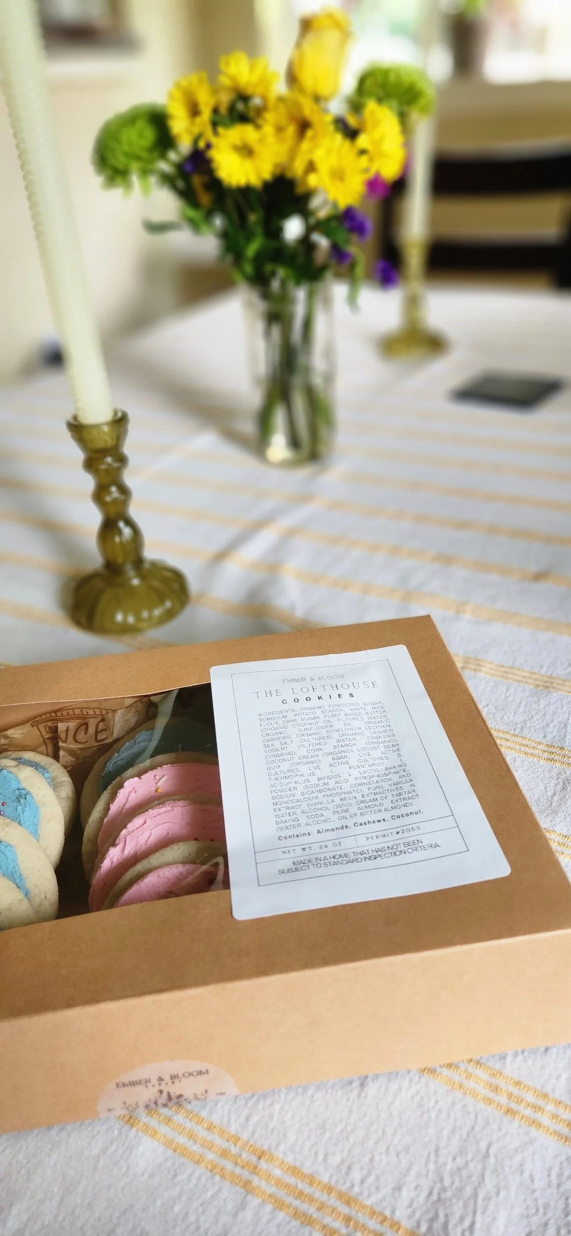 Hand-packaged box of Ember & Bloom gluten-free and vegan Lofthouse-style cookies featuring custom brand labeling and floral accents.