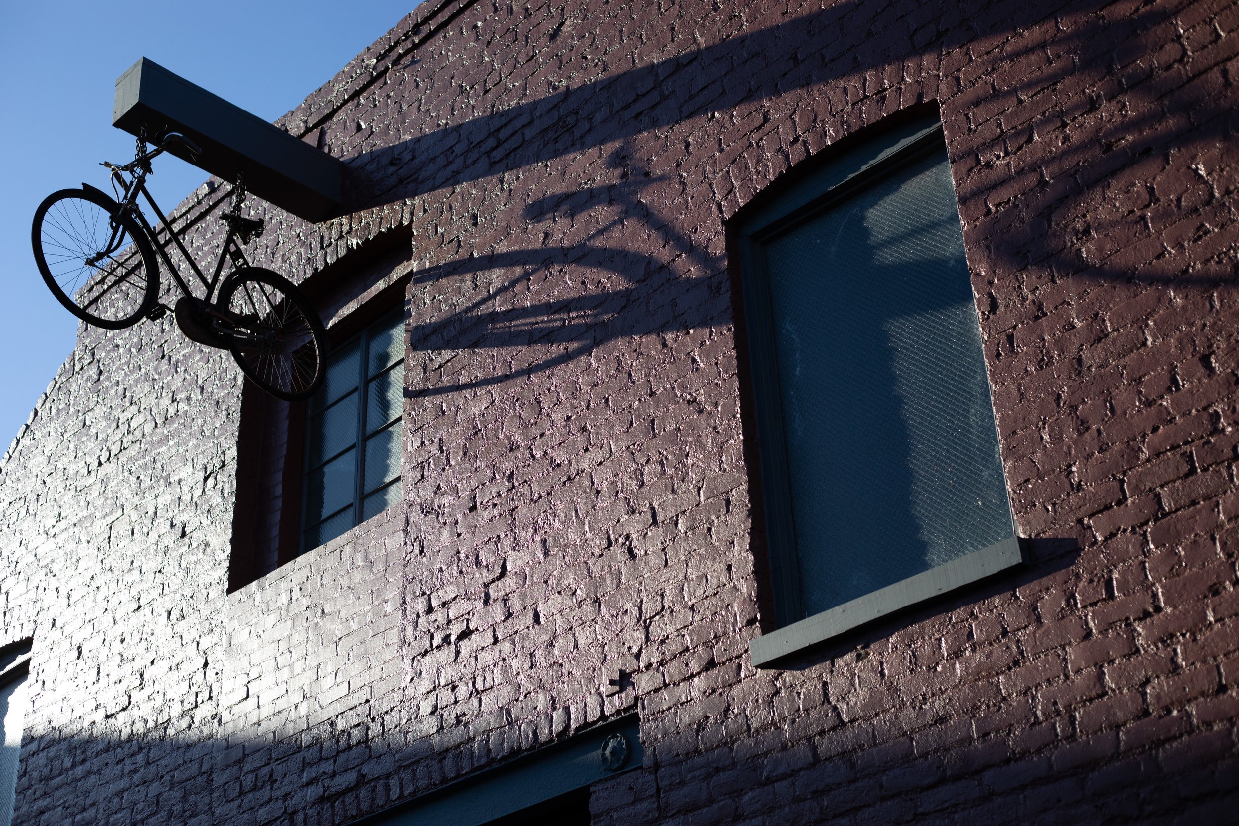 Bicycle silhouette, bracket shadow, brick wall, Richmond, Virginia