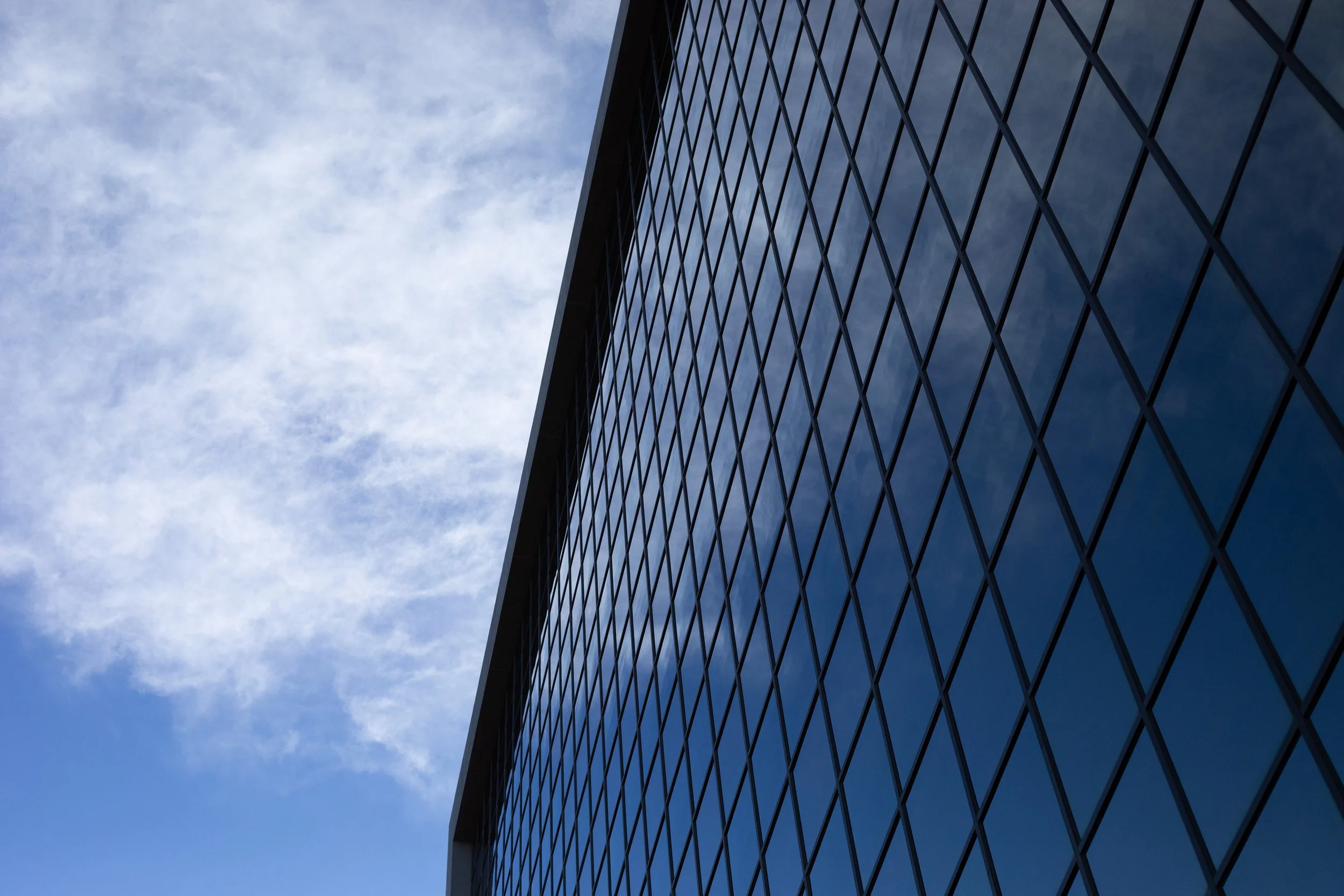 Glass curtain wall reflecting clouds, Denver, CO